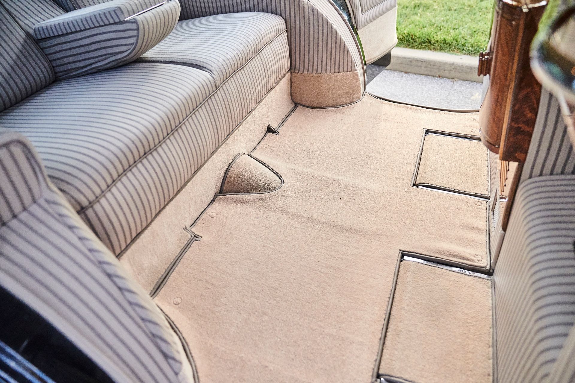 The inside of a car with a couch and a rug