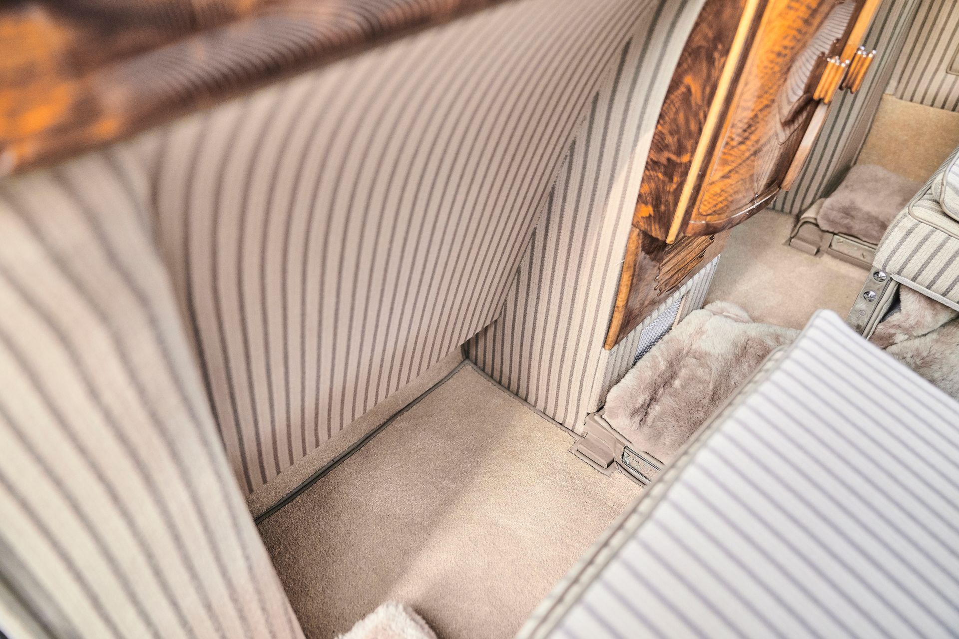 An aerial view of a room with a striped wall and a door.