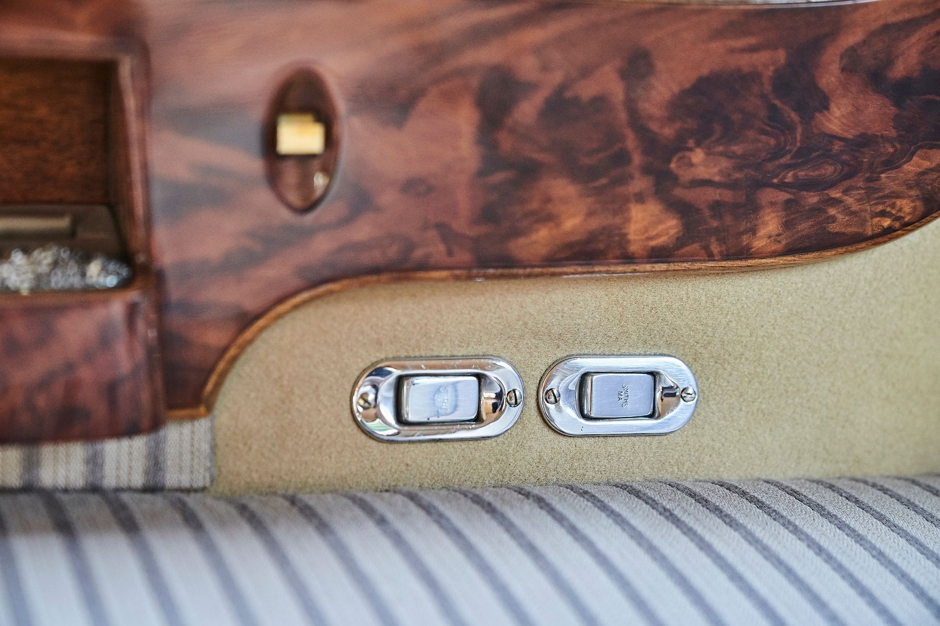 A close up of a car seat with two buttons on it.