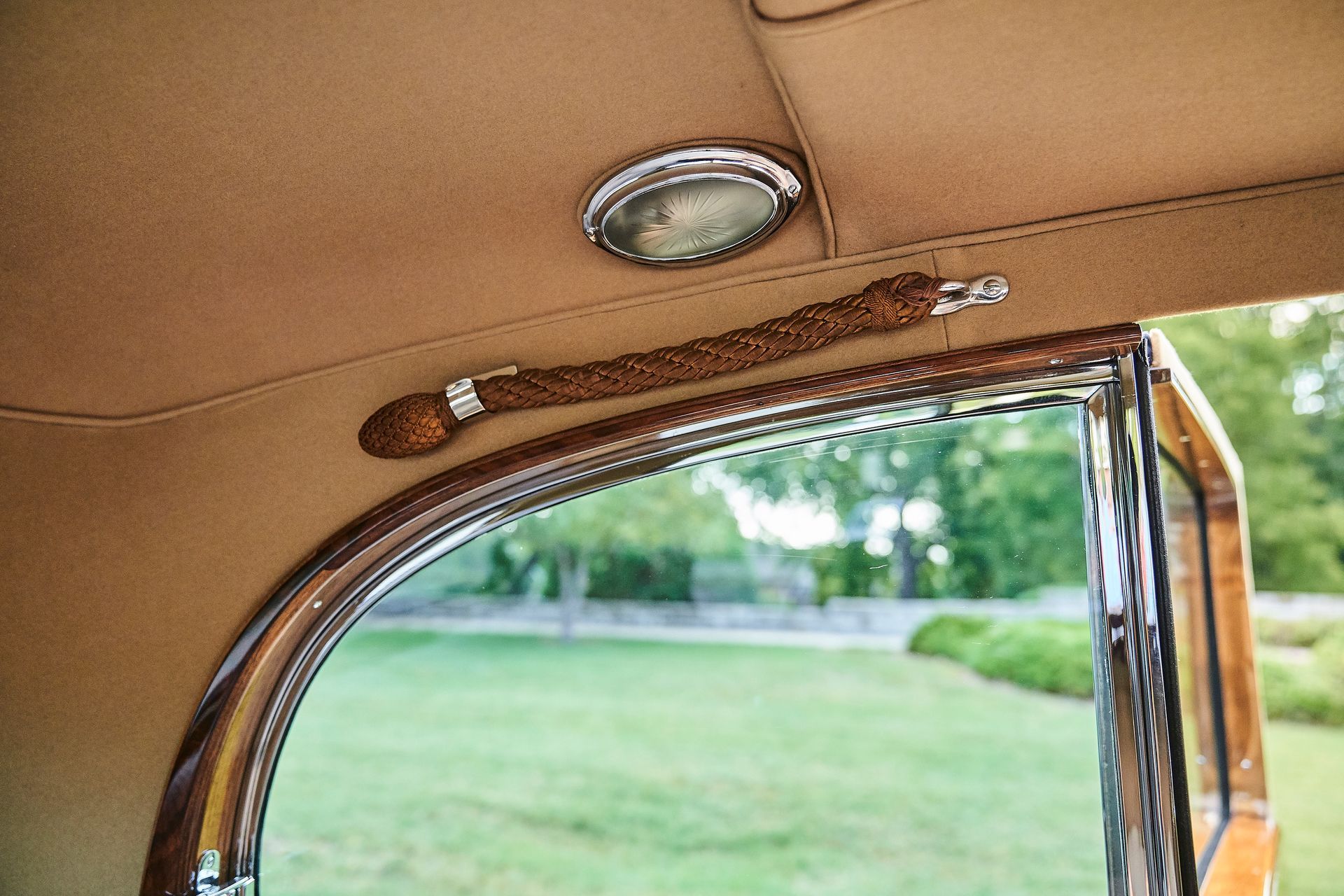 A close up of the inside of a car with a window open.