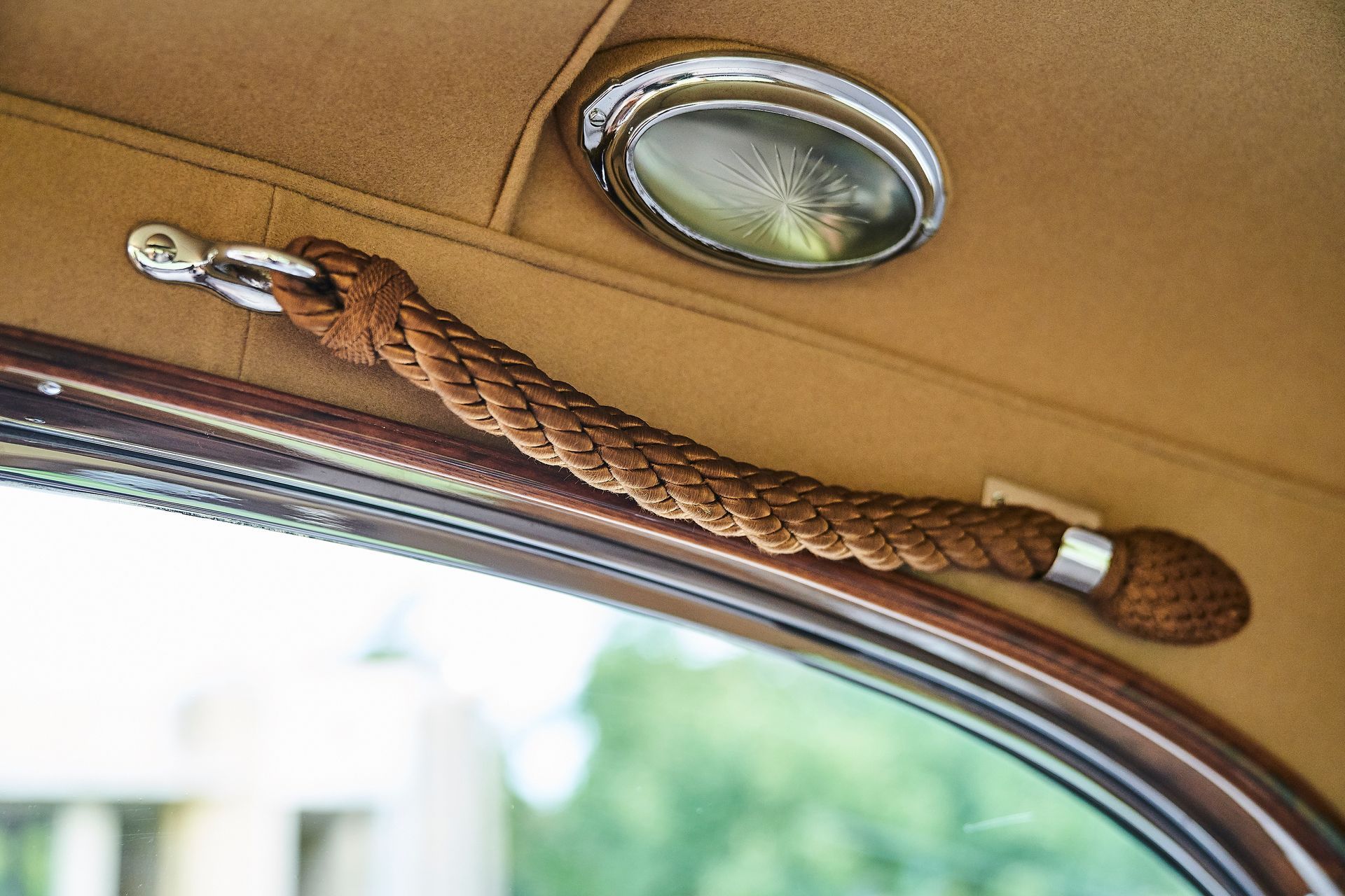 A rope is hanging from the ceiling of a car.