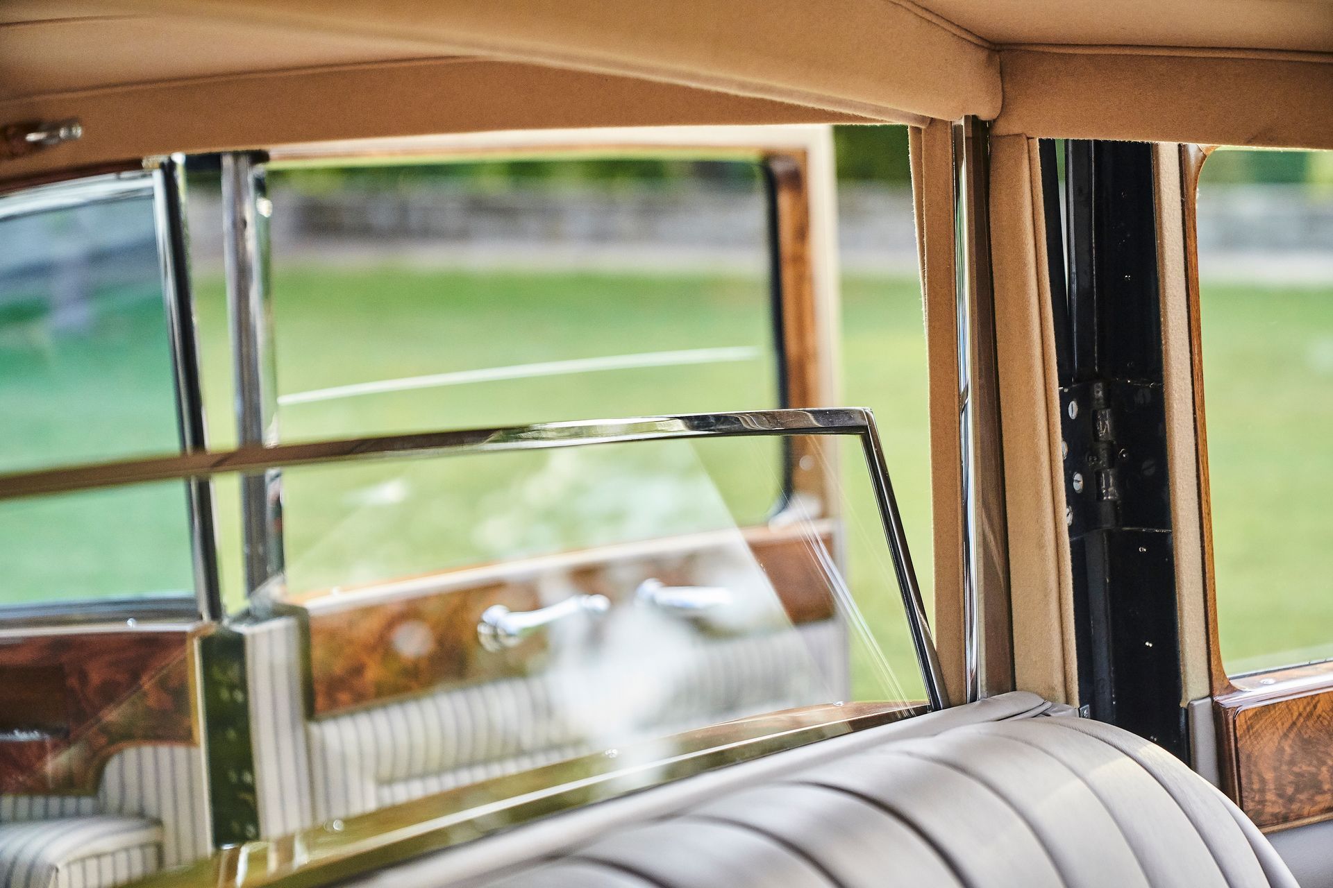 A close up of the inside of a car with a window open.