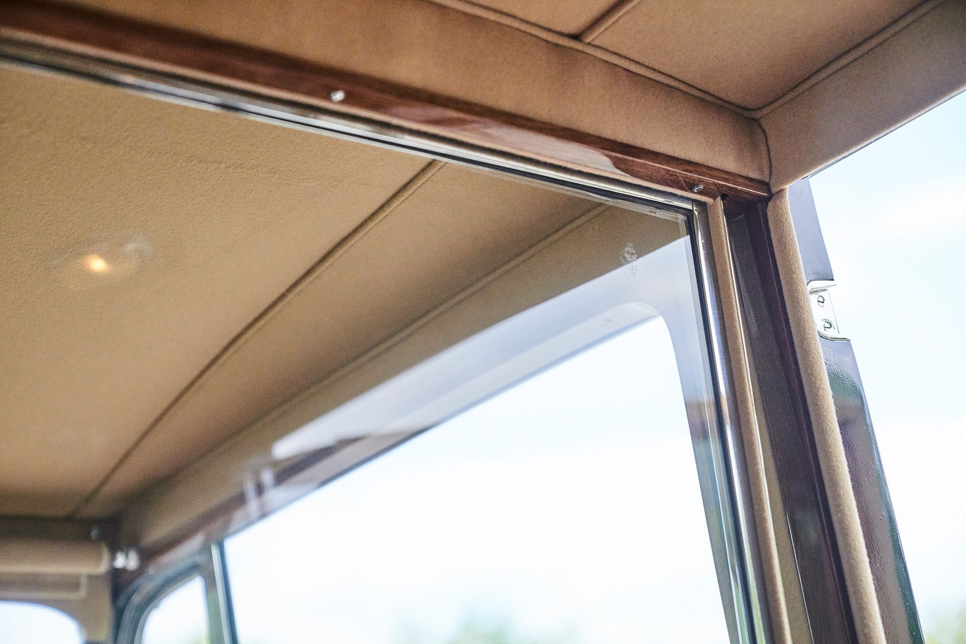 A close up of the inside of a car with a window.