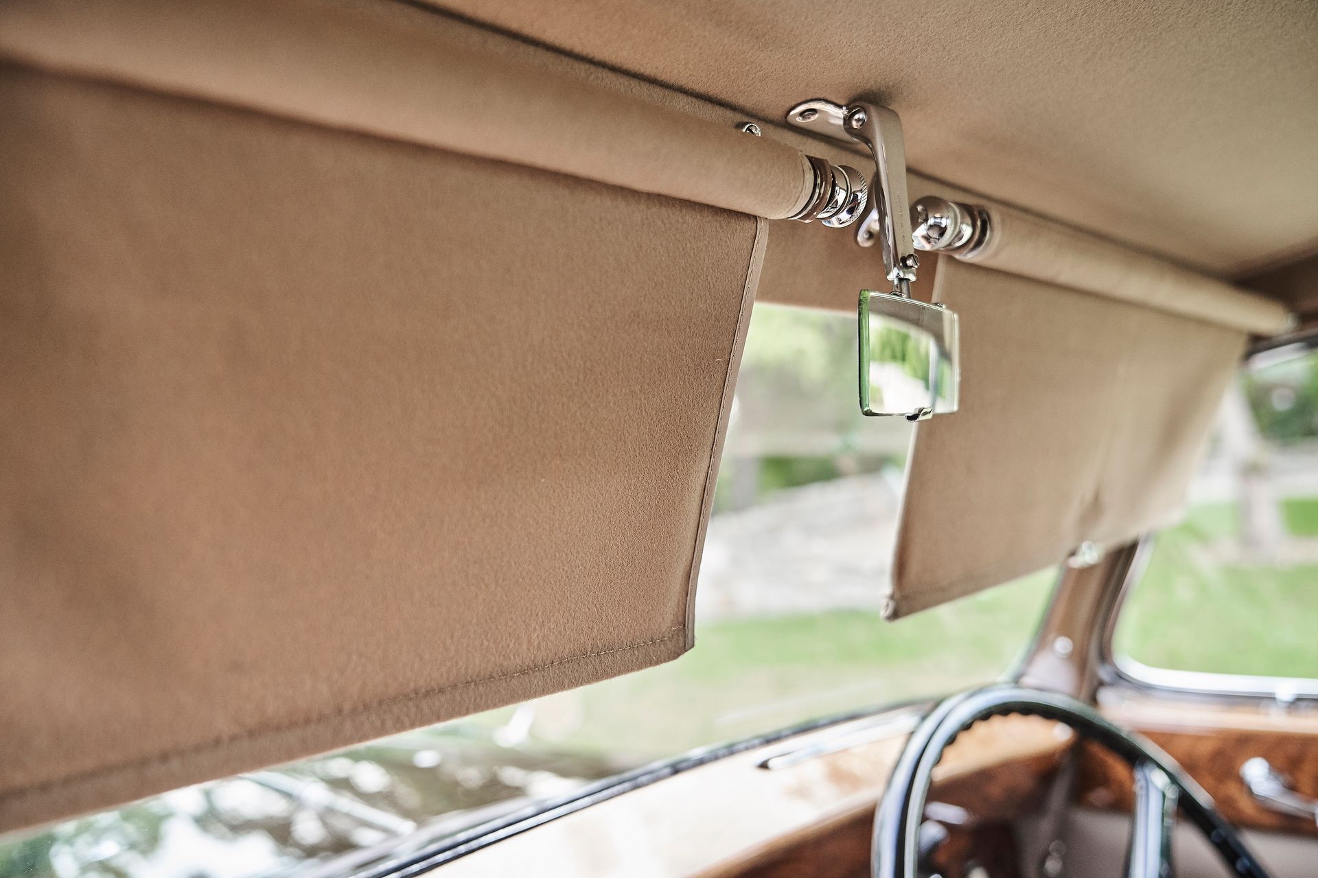 A close up of a sun visor in a car with a mirror attached to it.