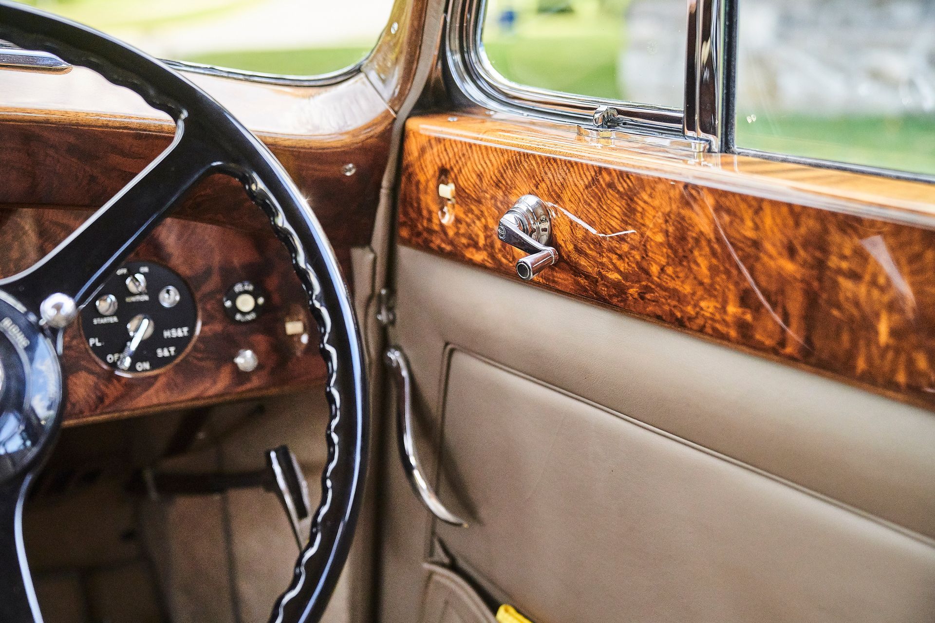 A close up of a car steering wheel and door