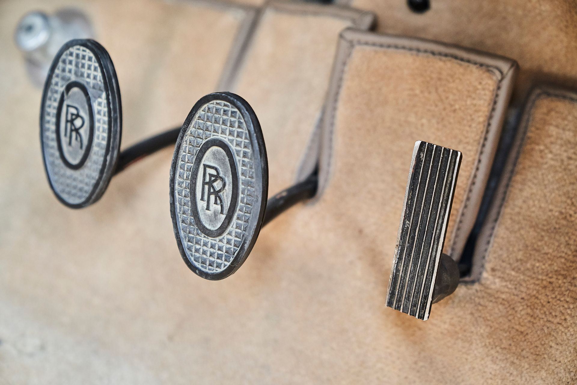 A close up of a car 's brake and clutch pedals
