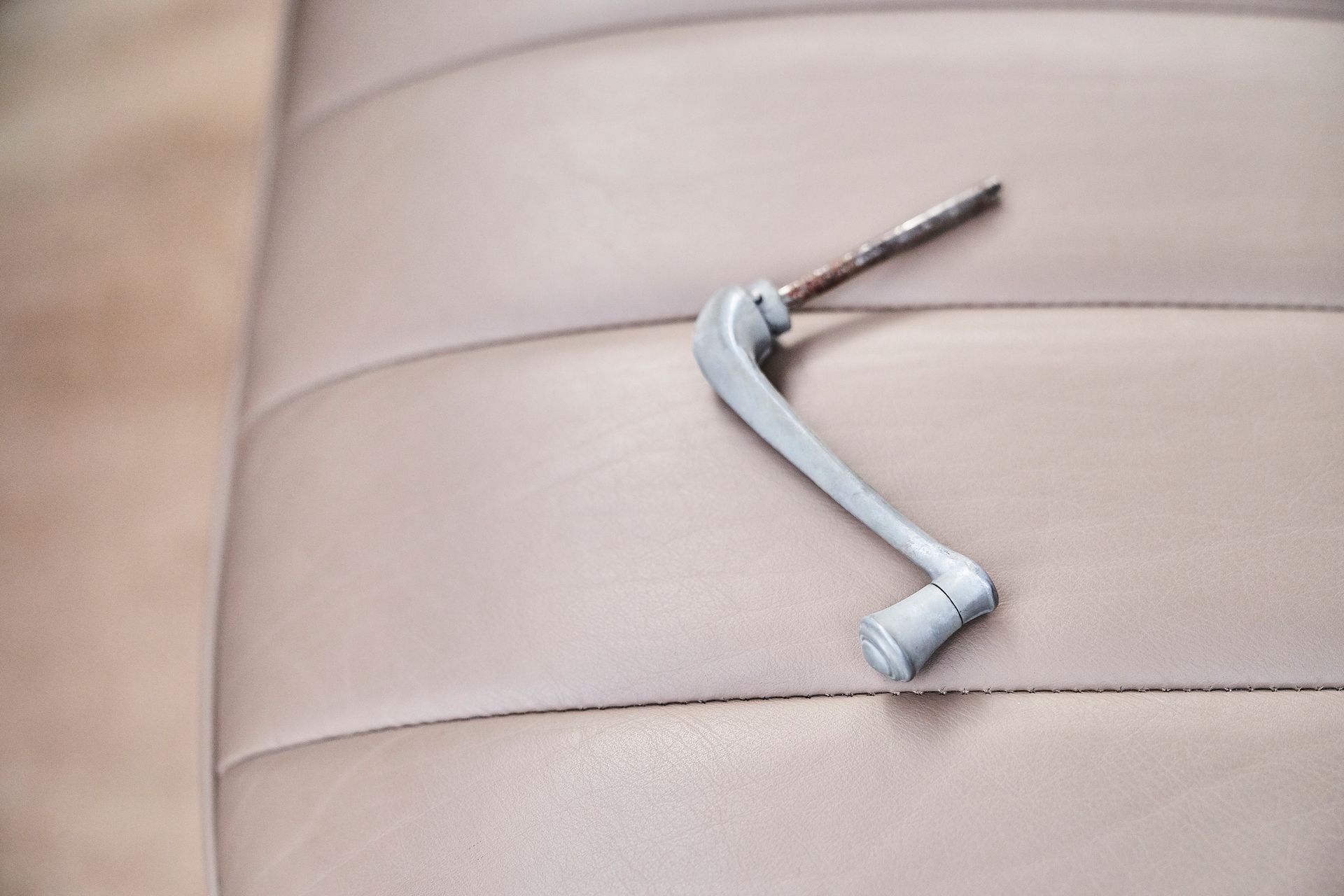 A close up of a door handle on a car seat