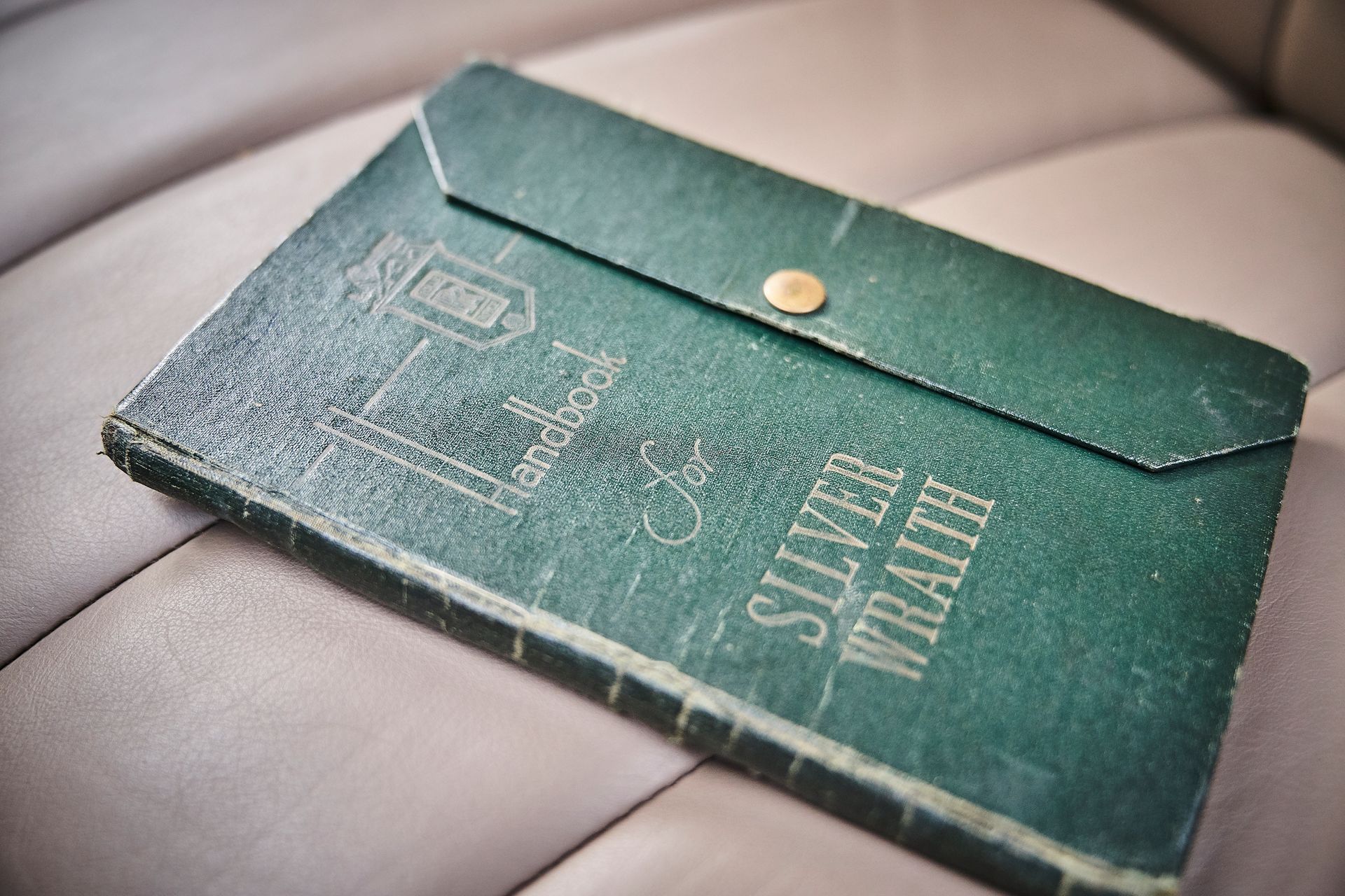 A book called silver wraith is sitting on a car seat