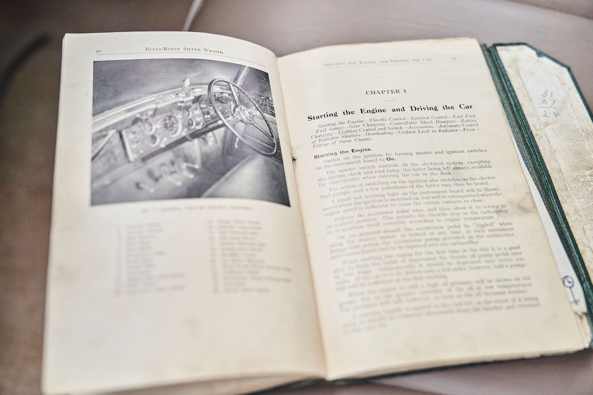 A book is open to a page with a picture of a car on it.
