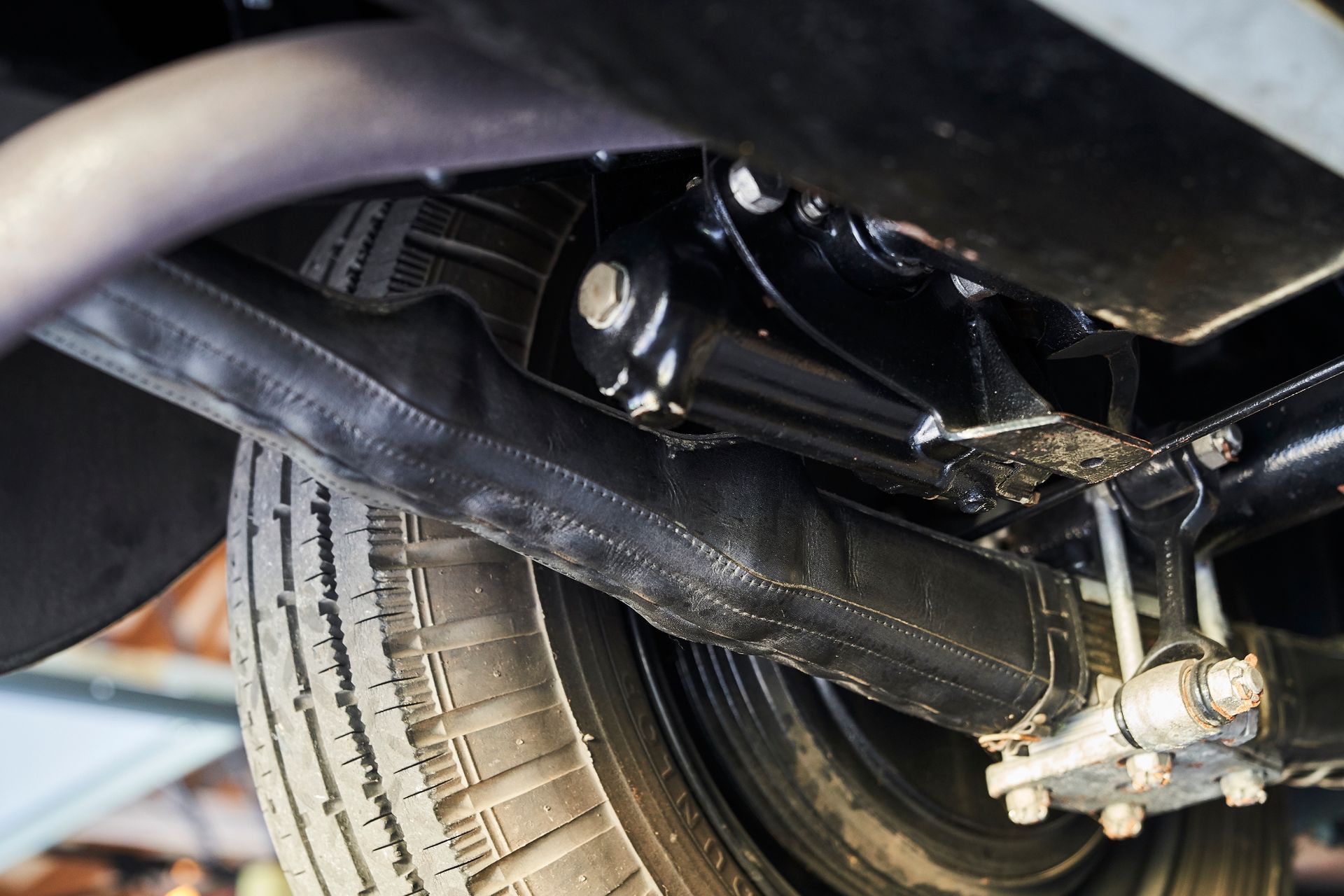 A close up of the underside of a car with a tire