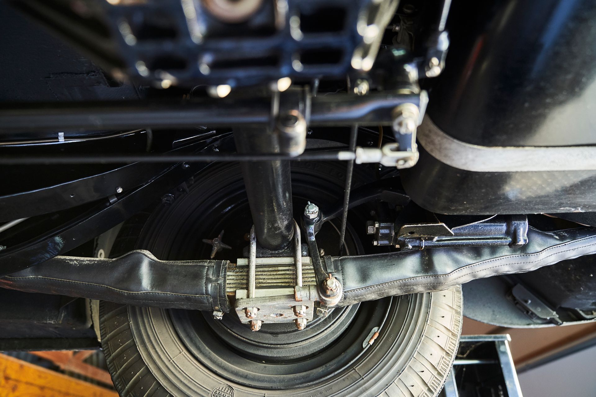 A close up of the underside of a car with a tire