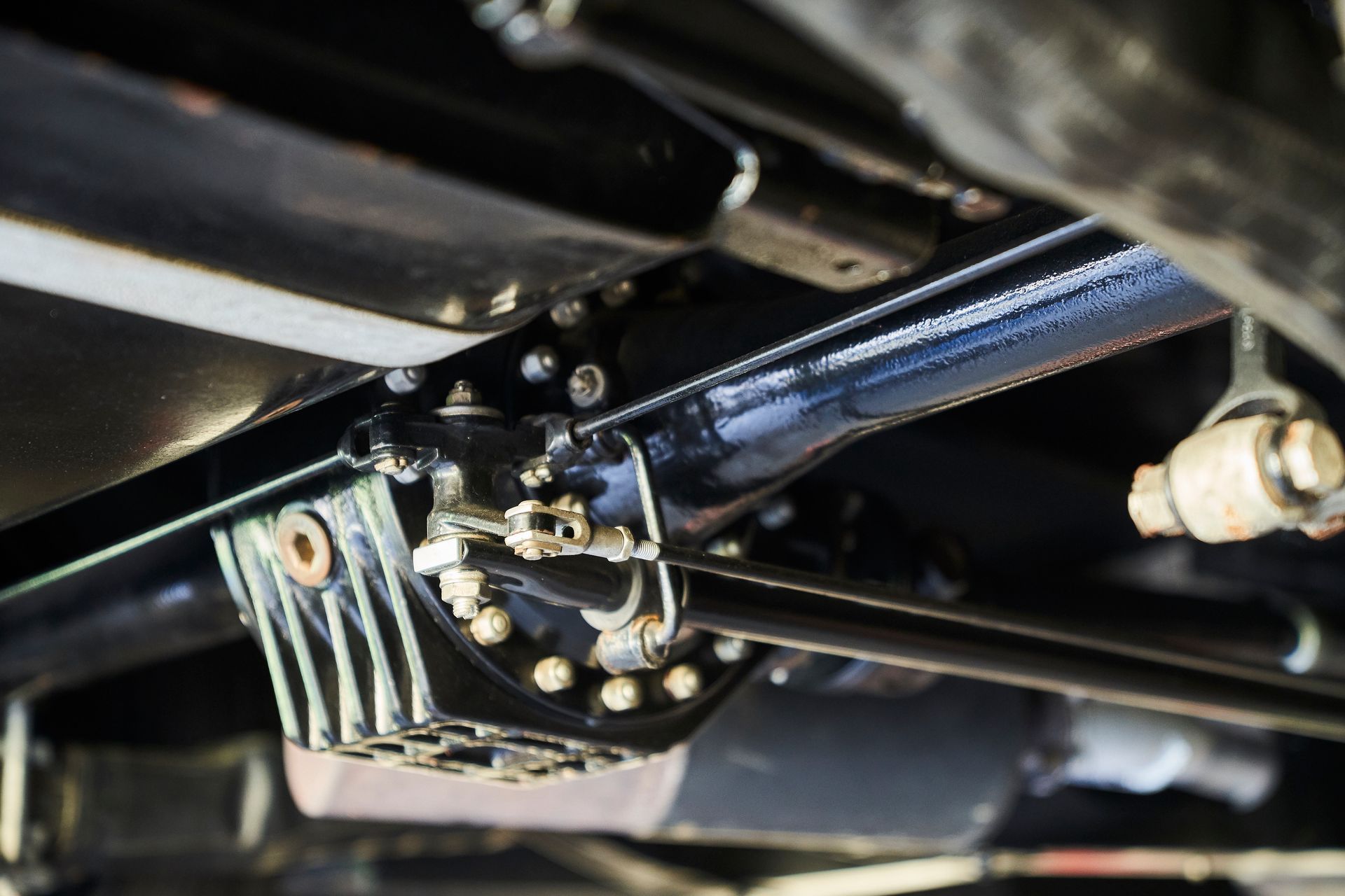A close up of the underside of a car 's suspension system.
