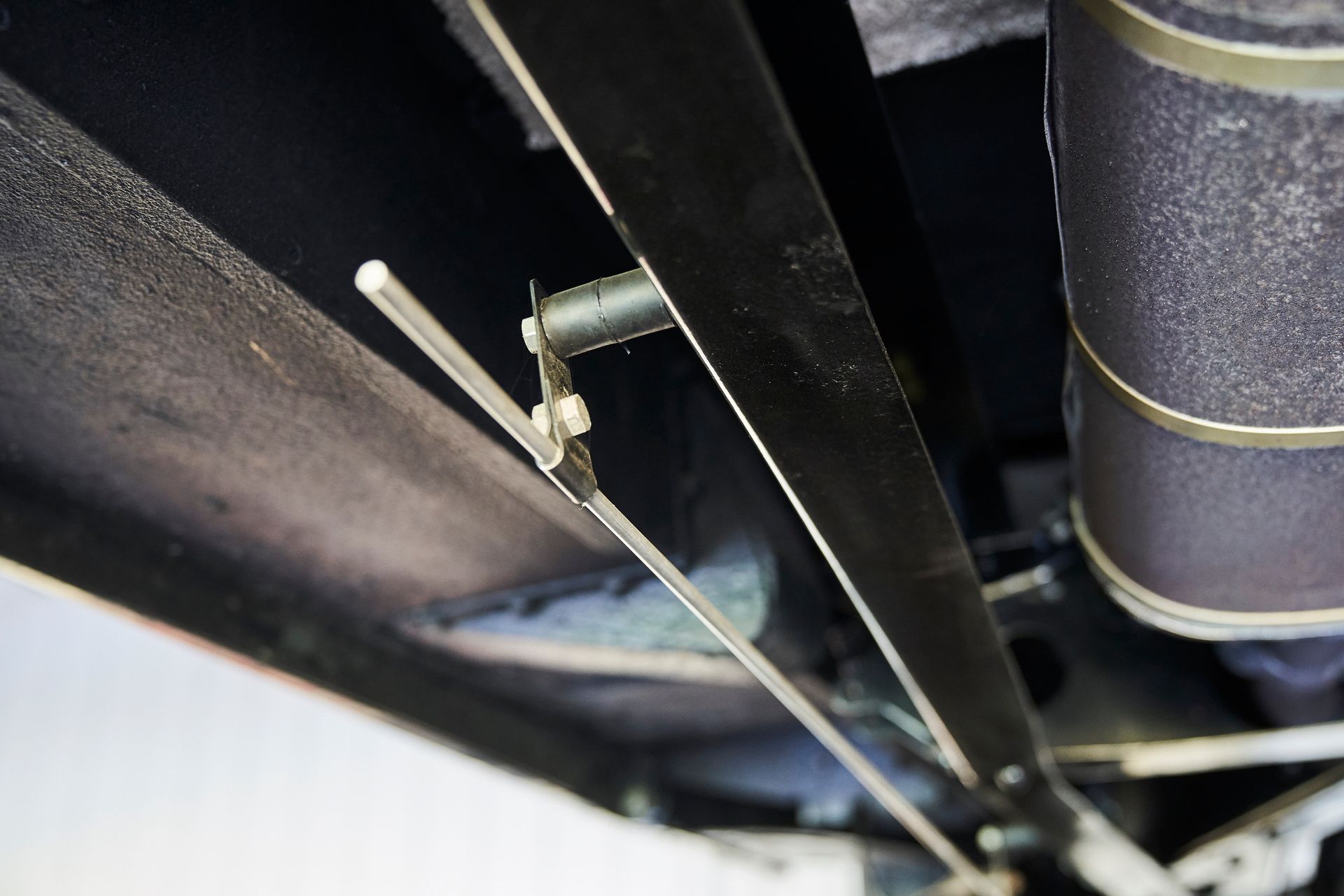 A close up of a metal pipe hanging from the ceiling of a vehicle.