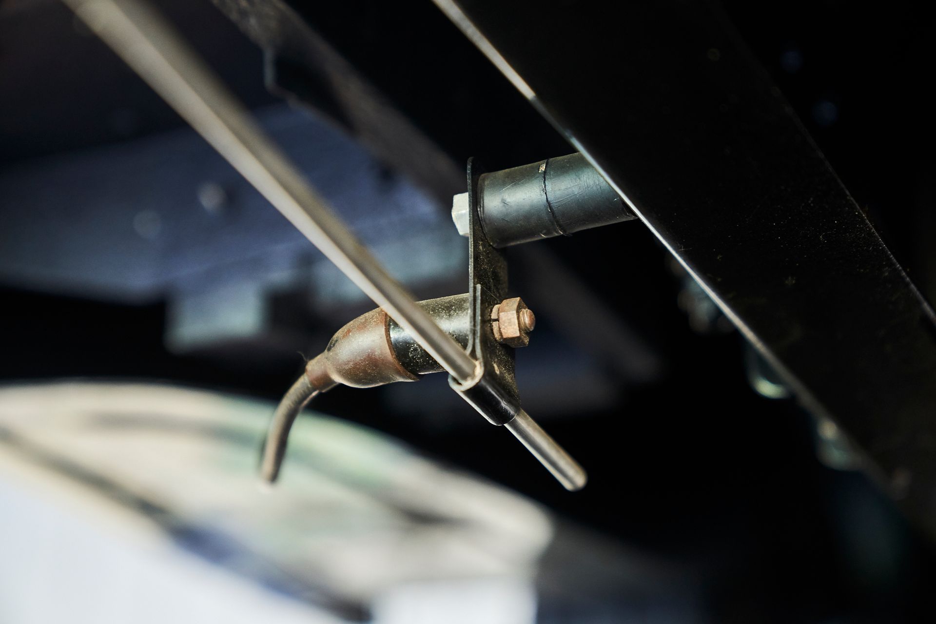 A close up of a hose attached to the side of a vehicle