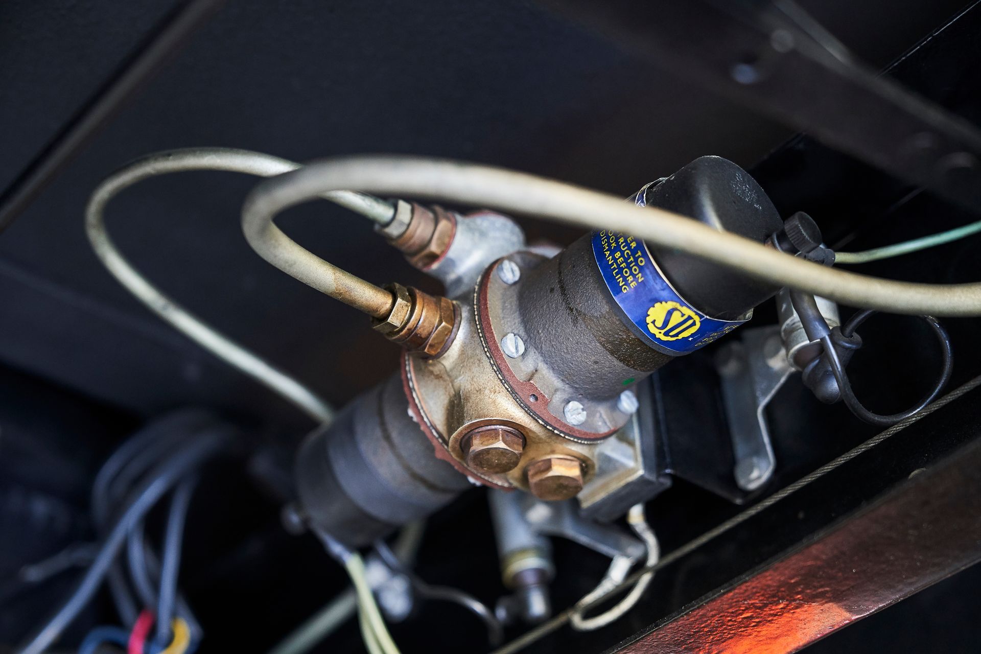 A close up of a fuel pump with wires coming out of it.