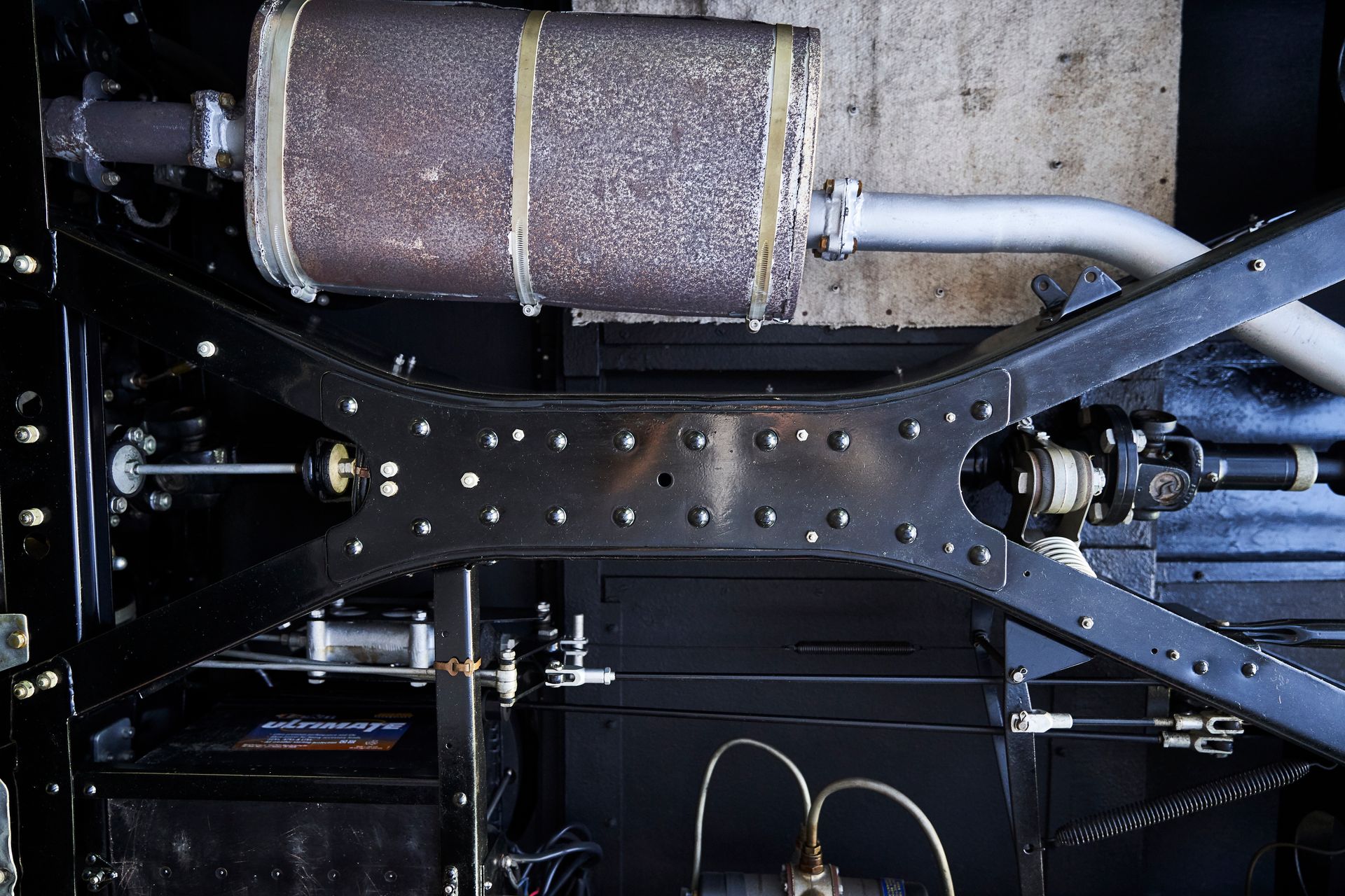 A close up of the underside of a car with a exhaust pipe