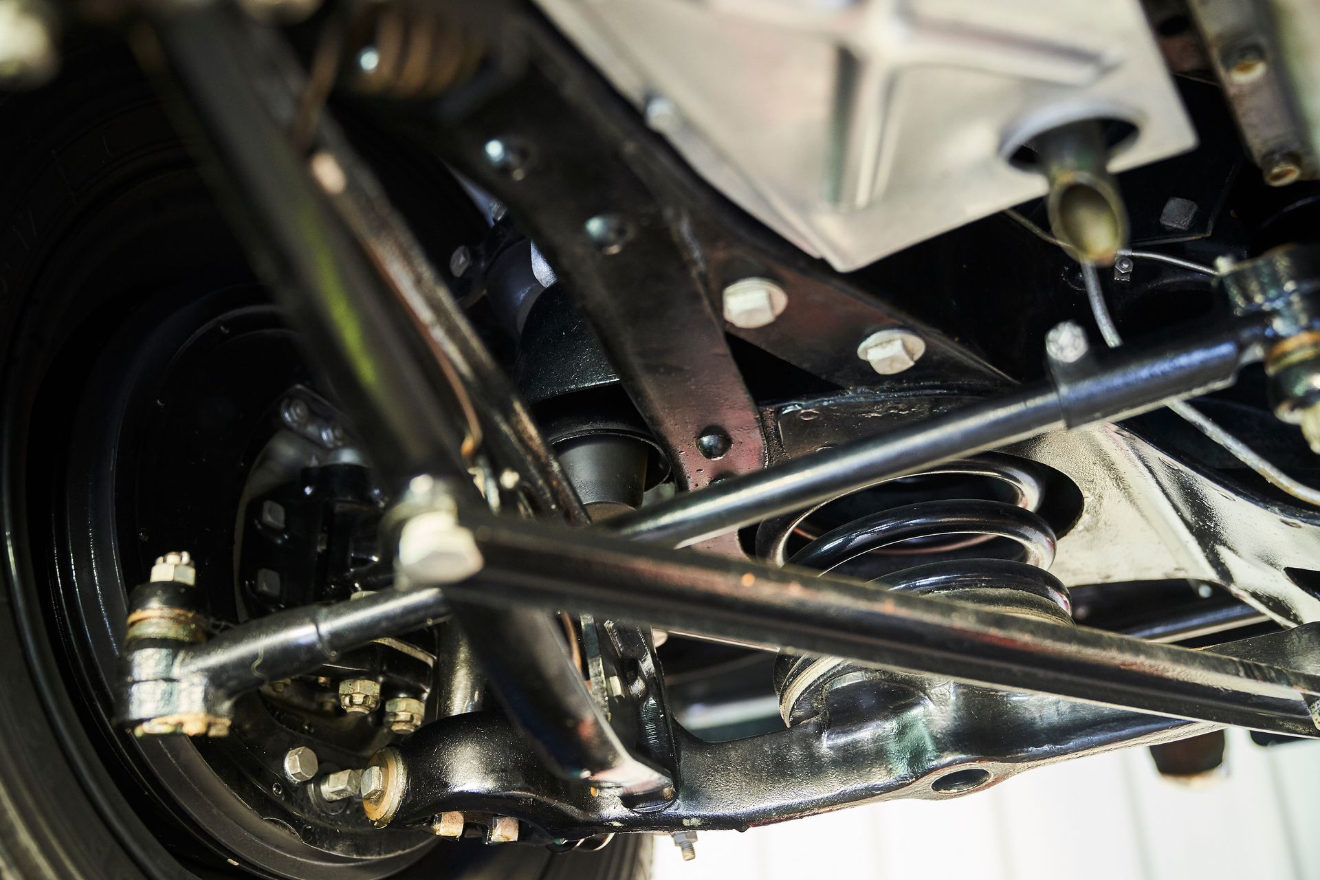 A close up of the underside of a car 's suspension system.