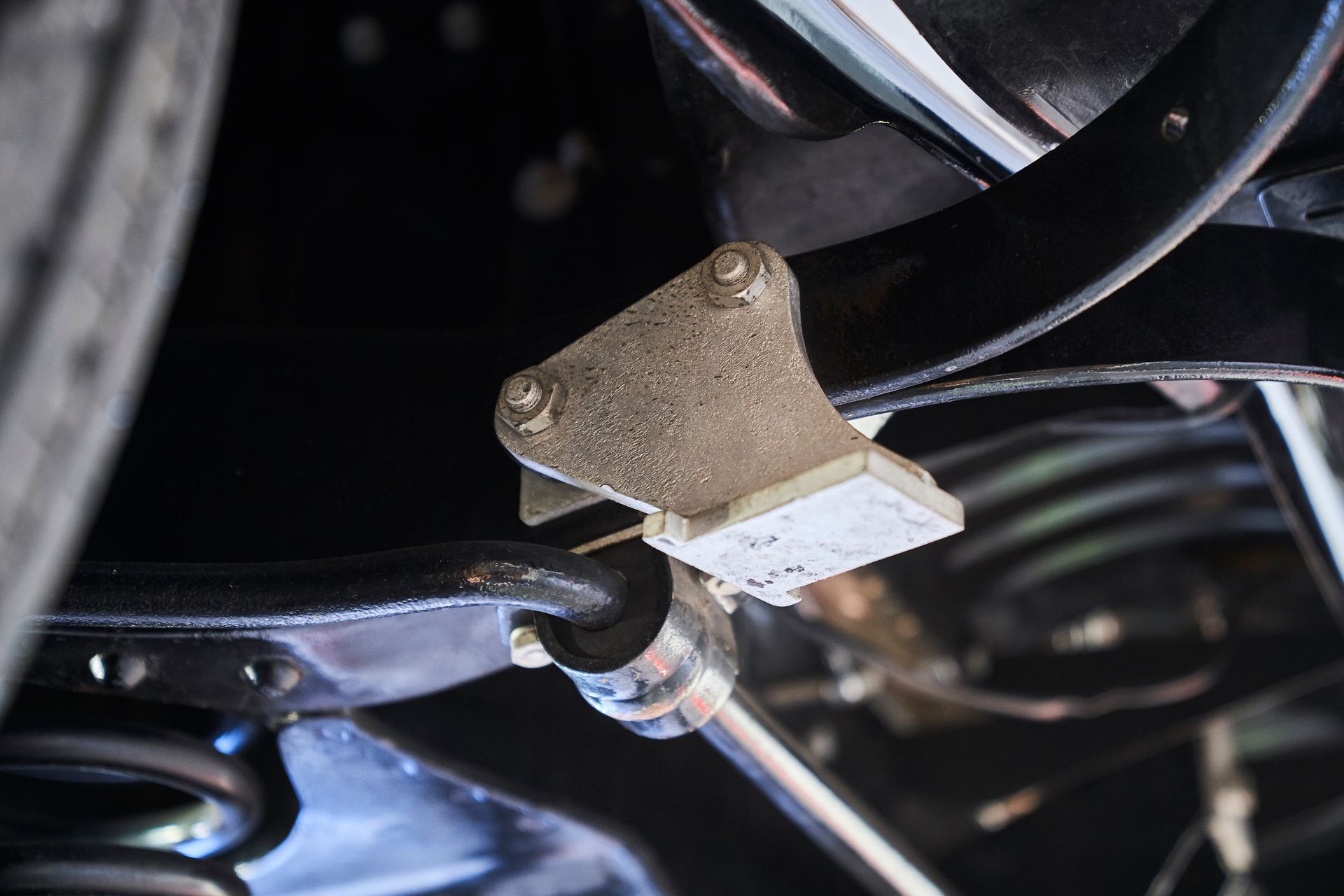 A close up of the underside of a car 's suspension system.