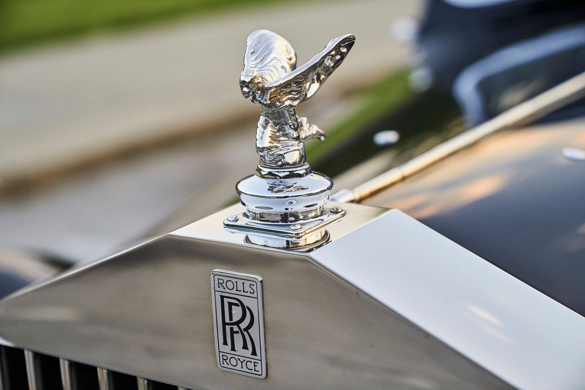 A close up of a hood ornament on a rolls royce car