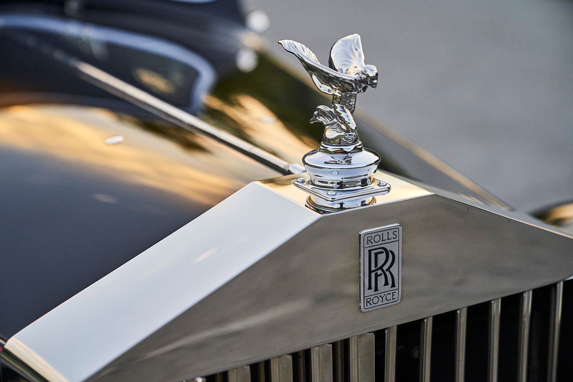 A close up of the hood of a rolls royce car