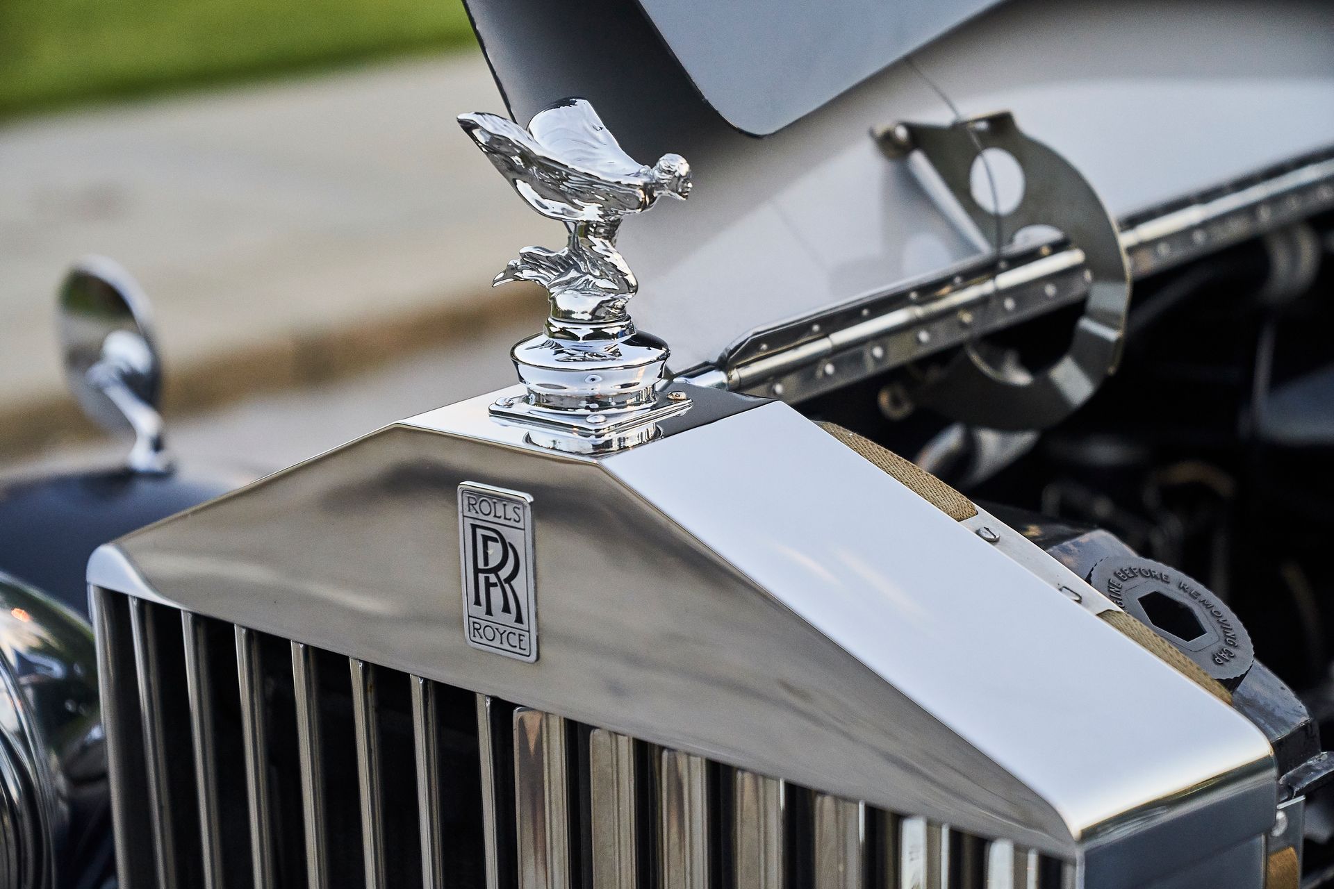 A close up of a rolls royce car with the hood up
