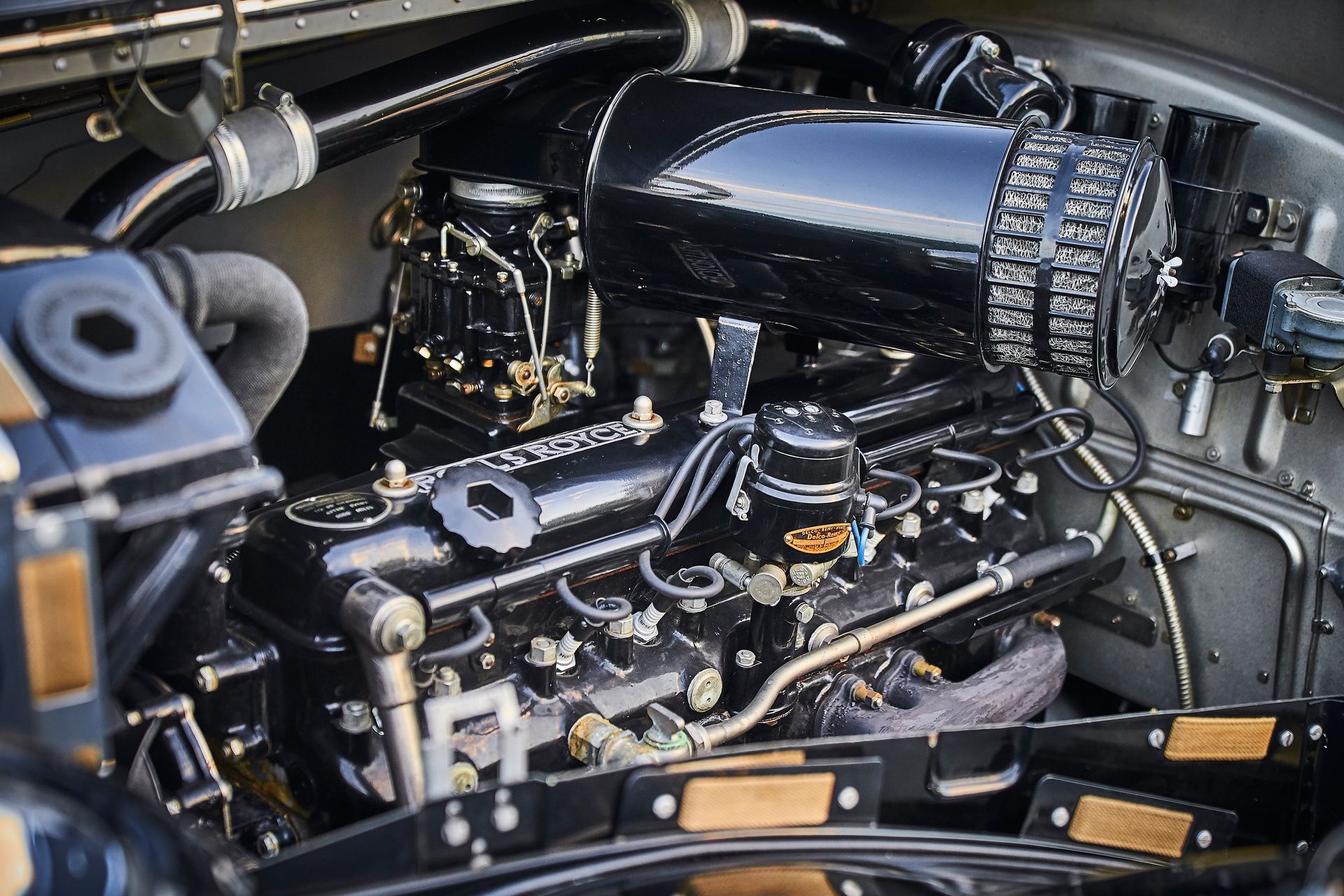 A close up of a car engine with the hood open.
