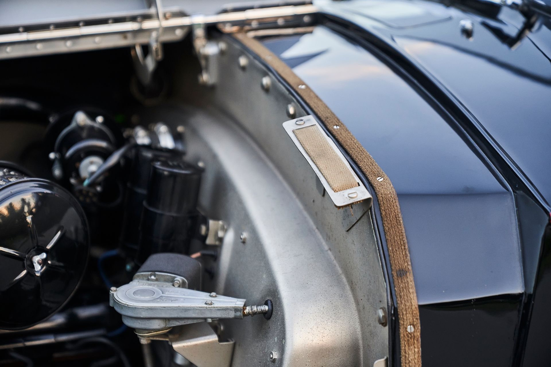 A close up of a car engine with the hood open.