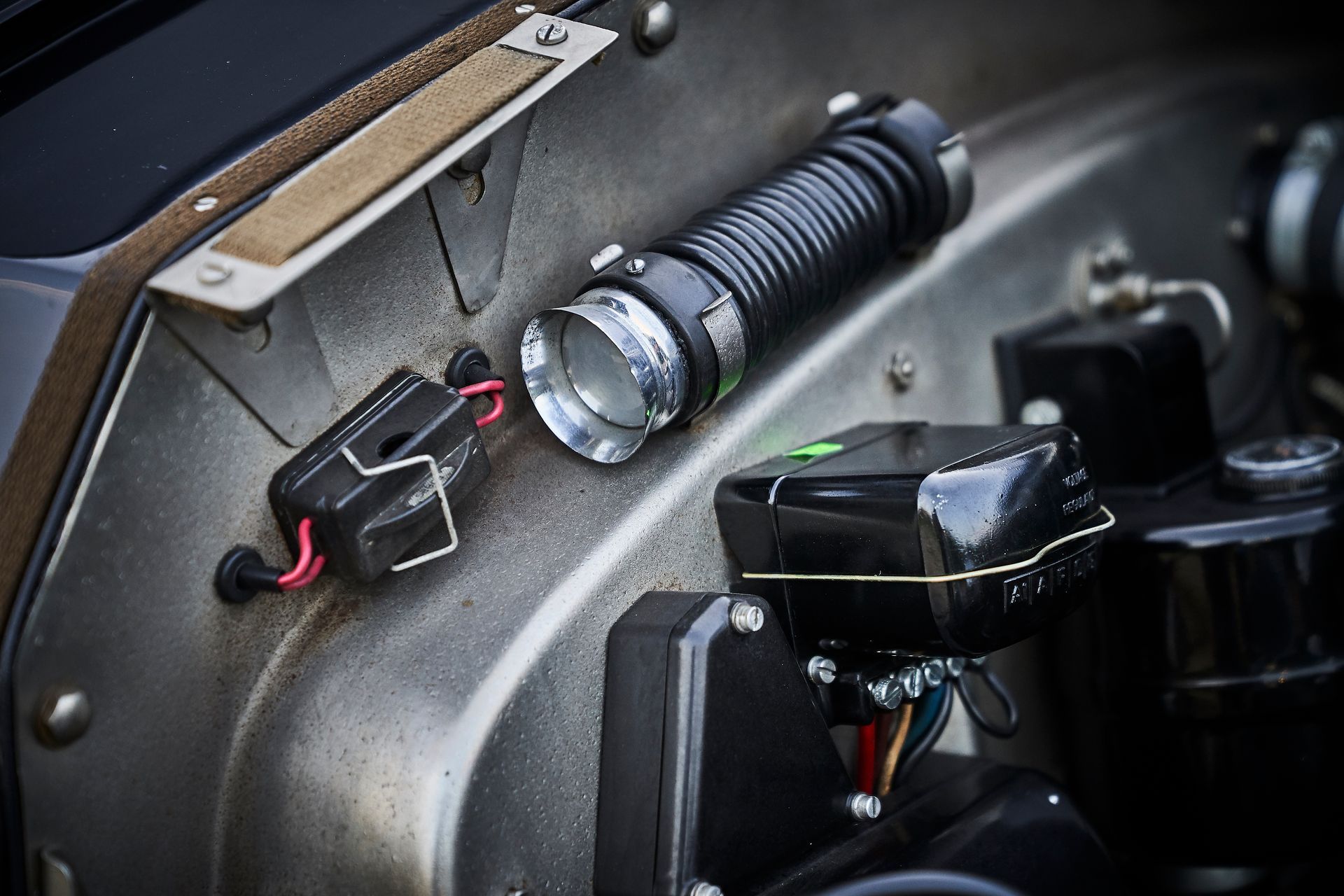 A close up of a flashlight sitting on top of a metal surface.