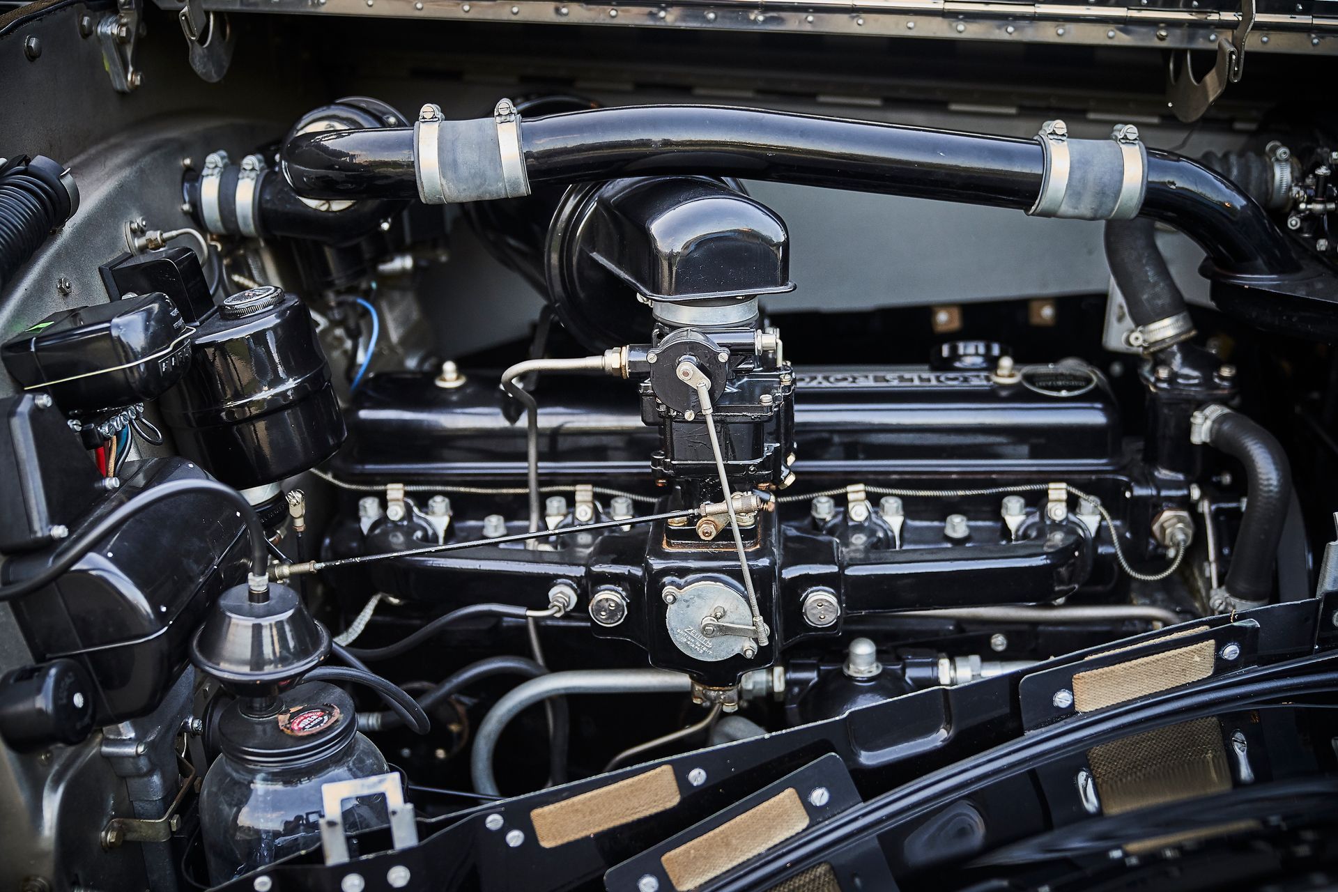 A close up of a car engine with the hood open