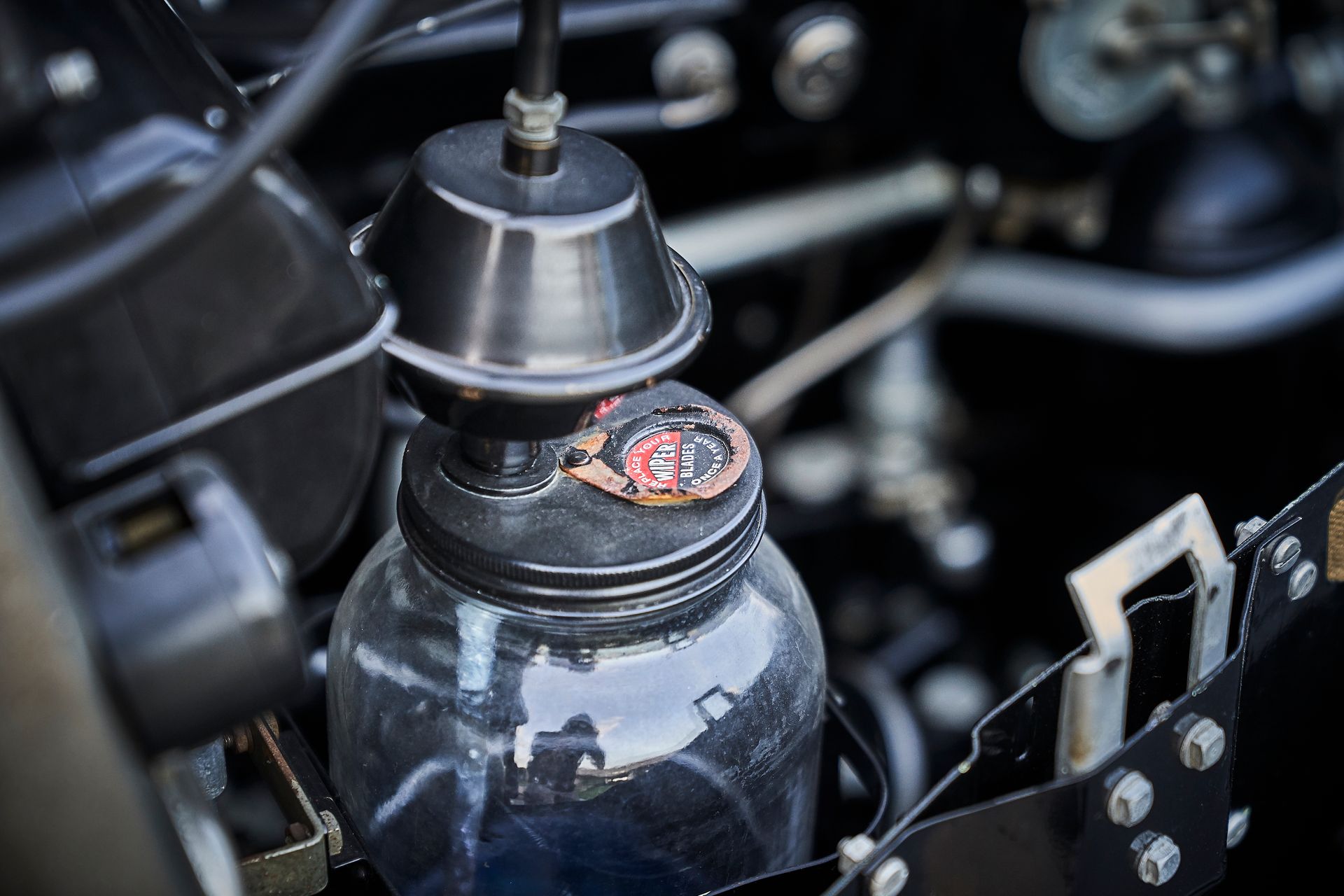 A close up of a jar in the engine of a car.