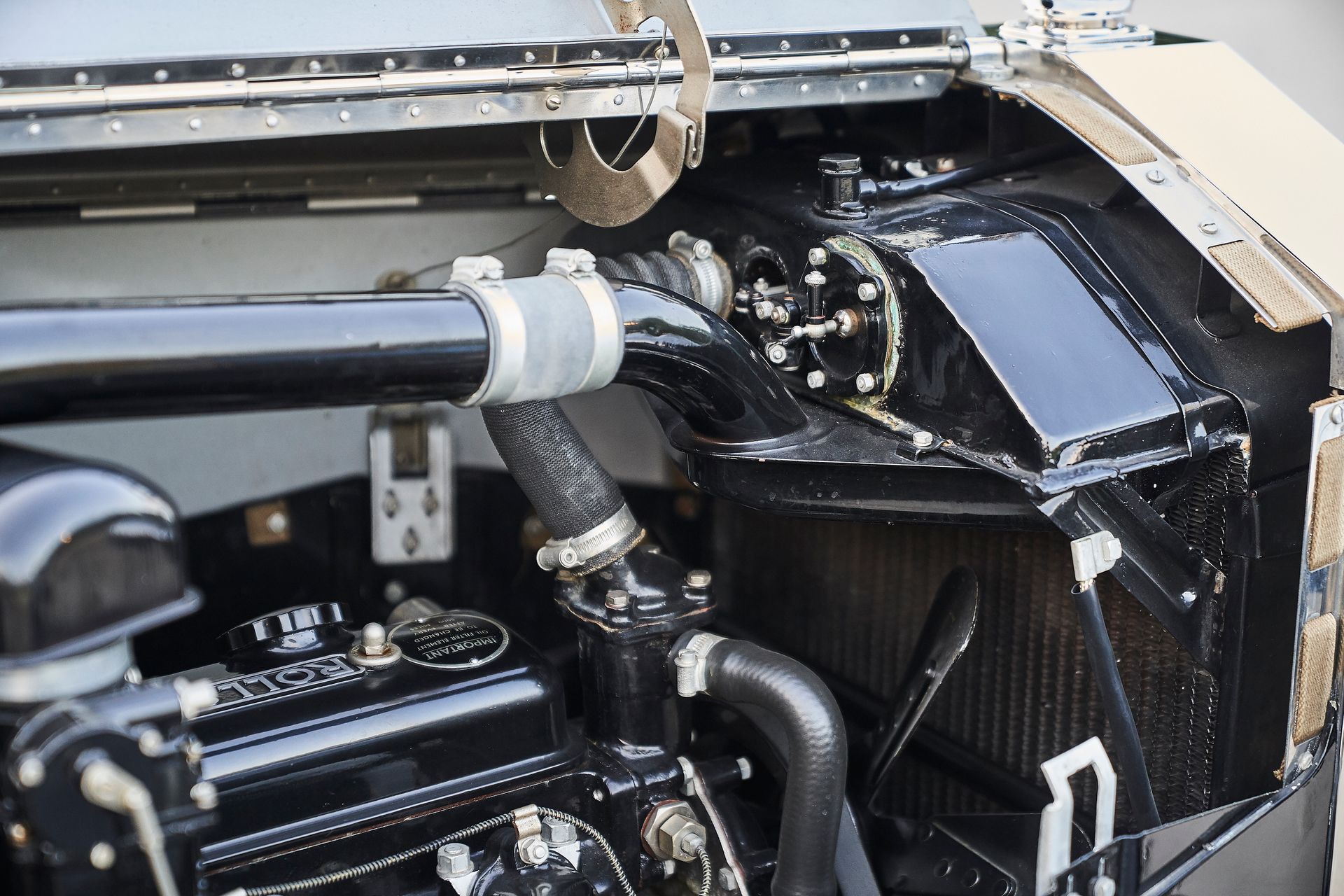 A close up of a black car engine with a radiator