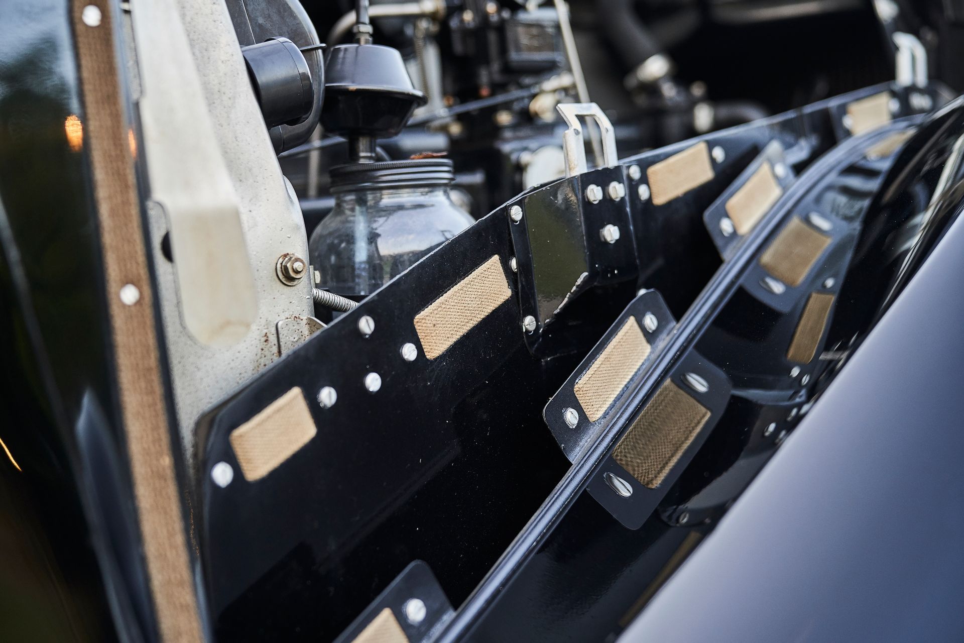 A close up of a car engine with the hood open.