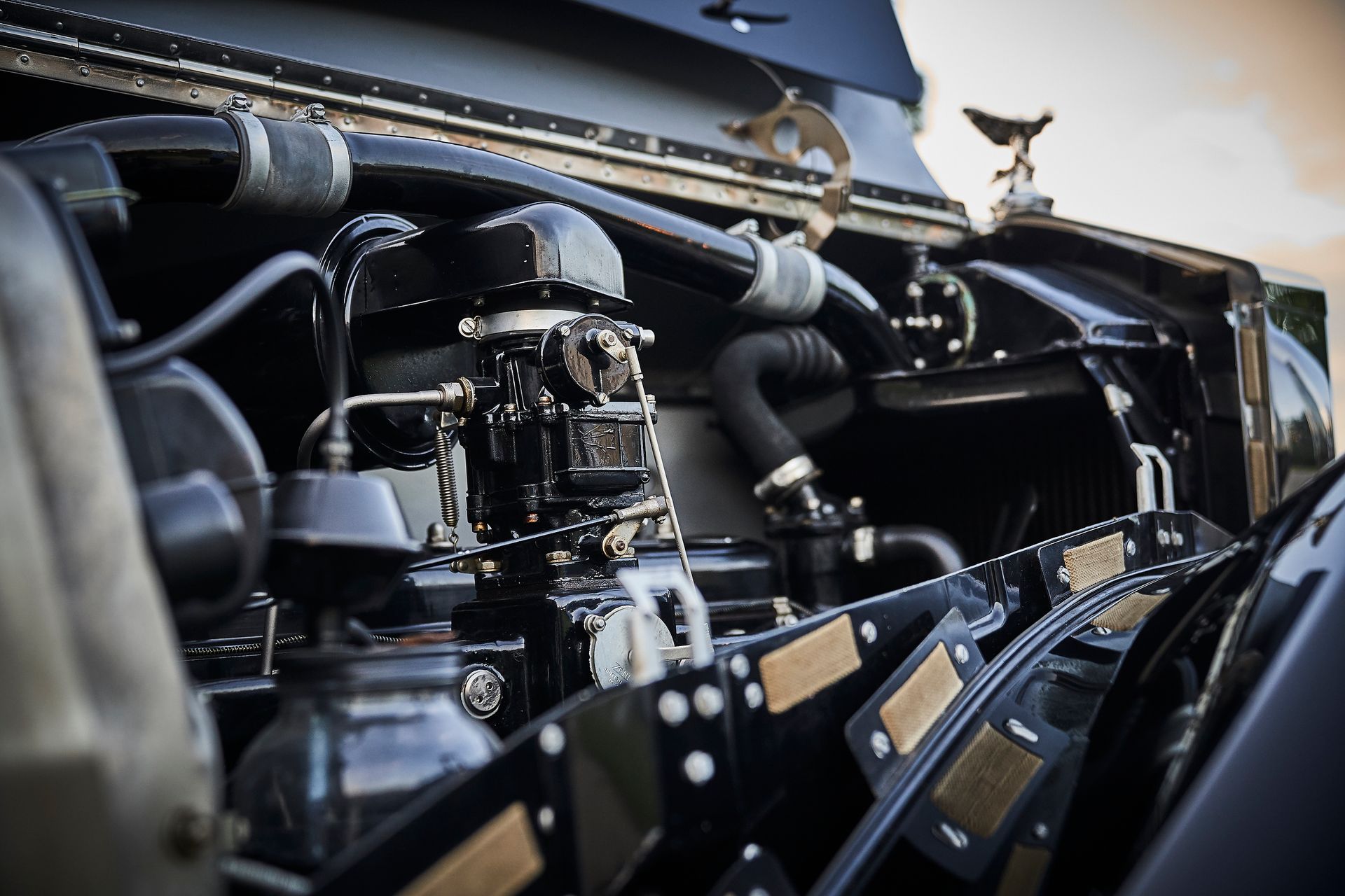 A close up of a car engine with the hood open