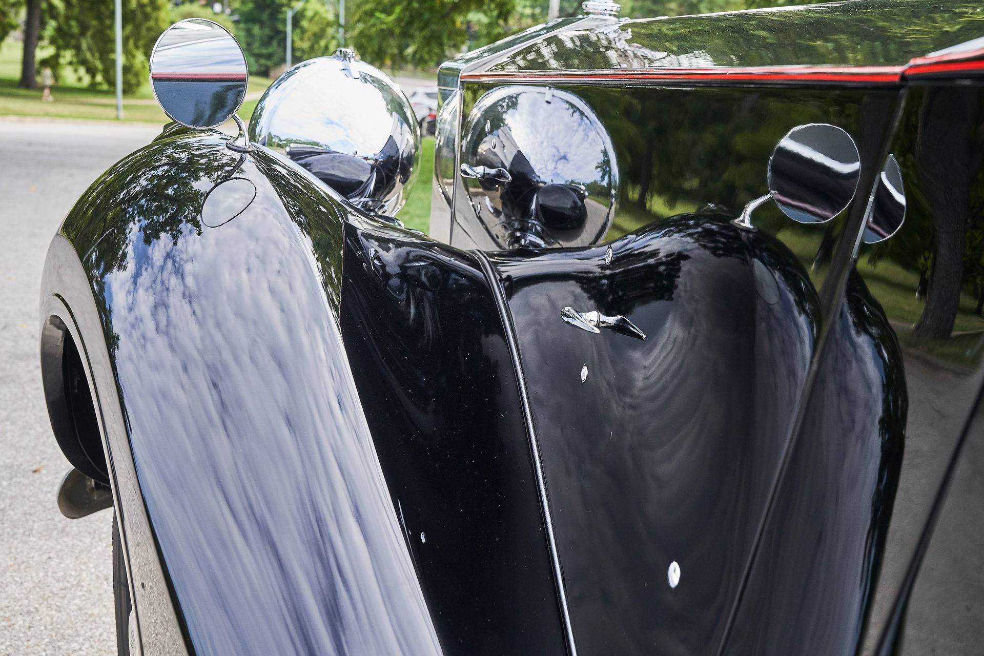 A black car is parked on the side of the road