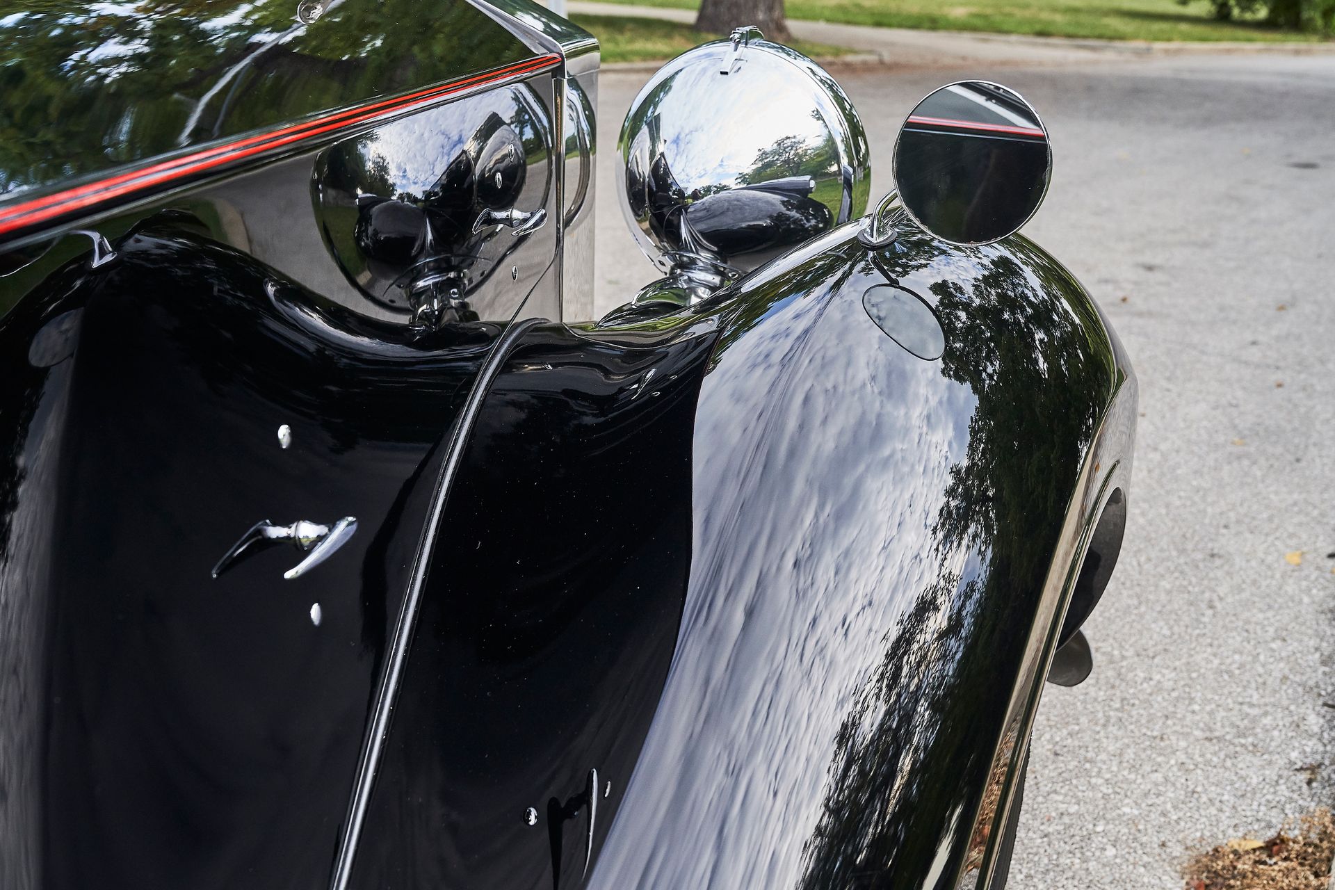 A black car is parked on the side of the road