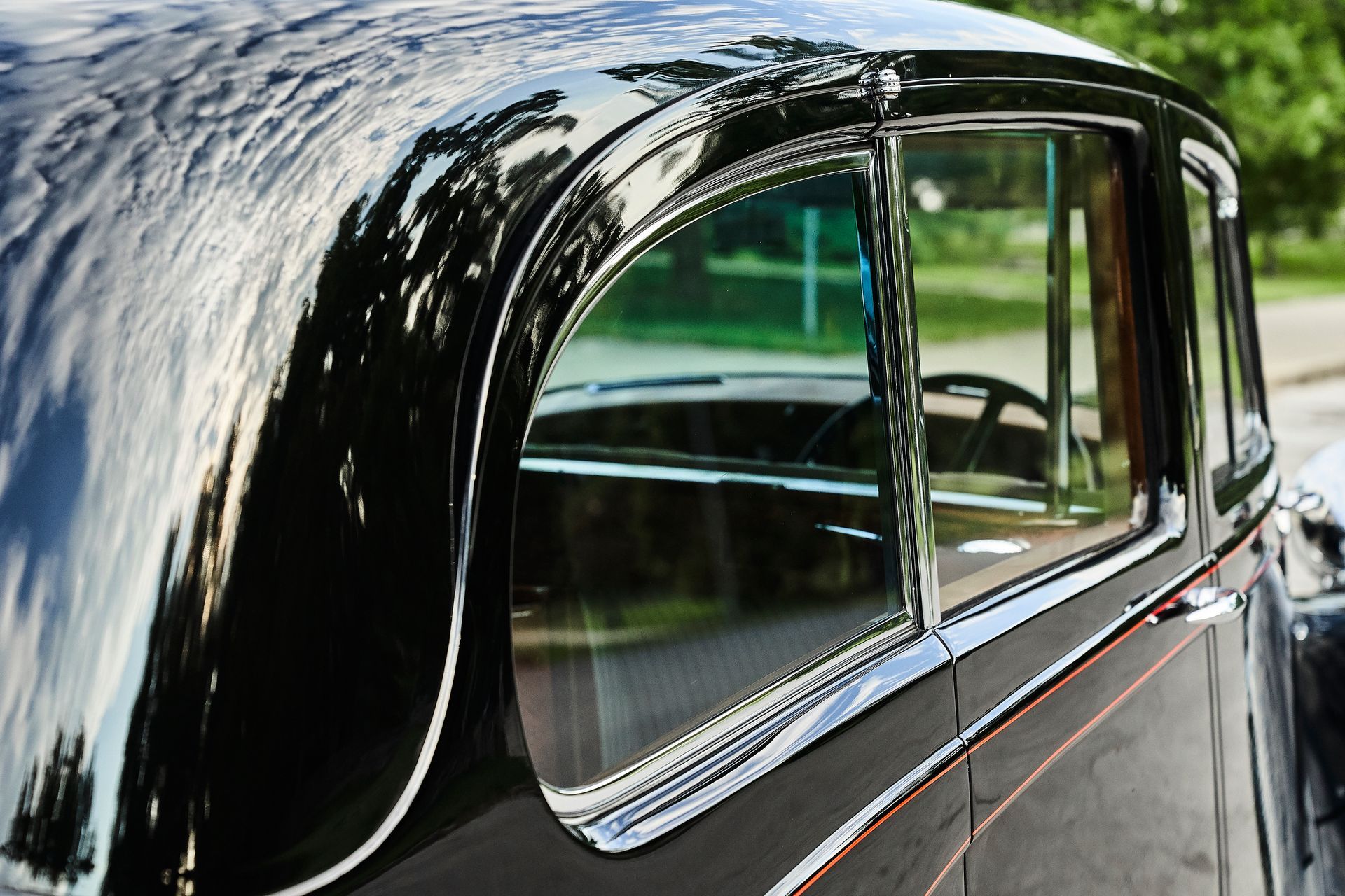 A black car is parked on the side of the road.