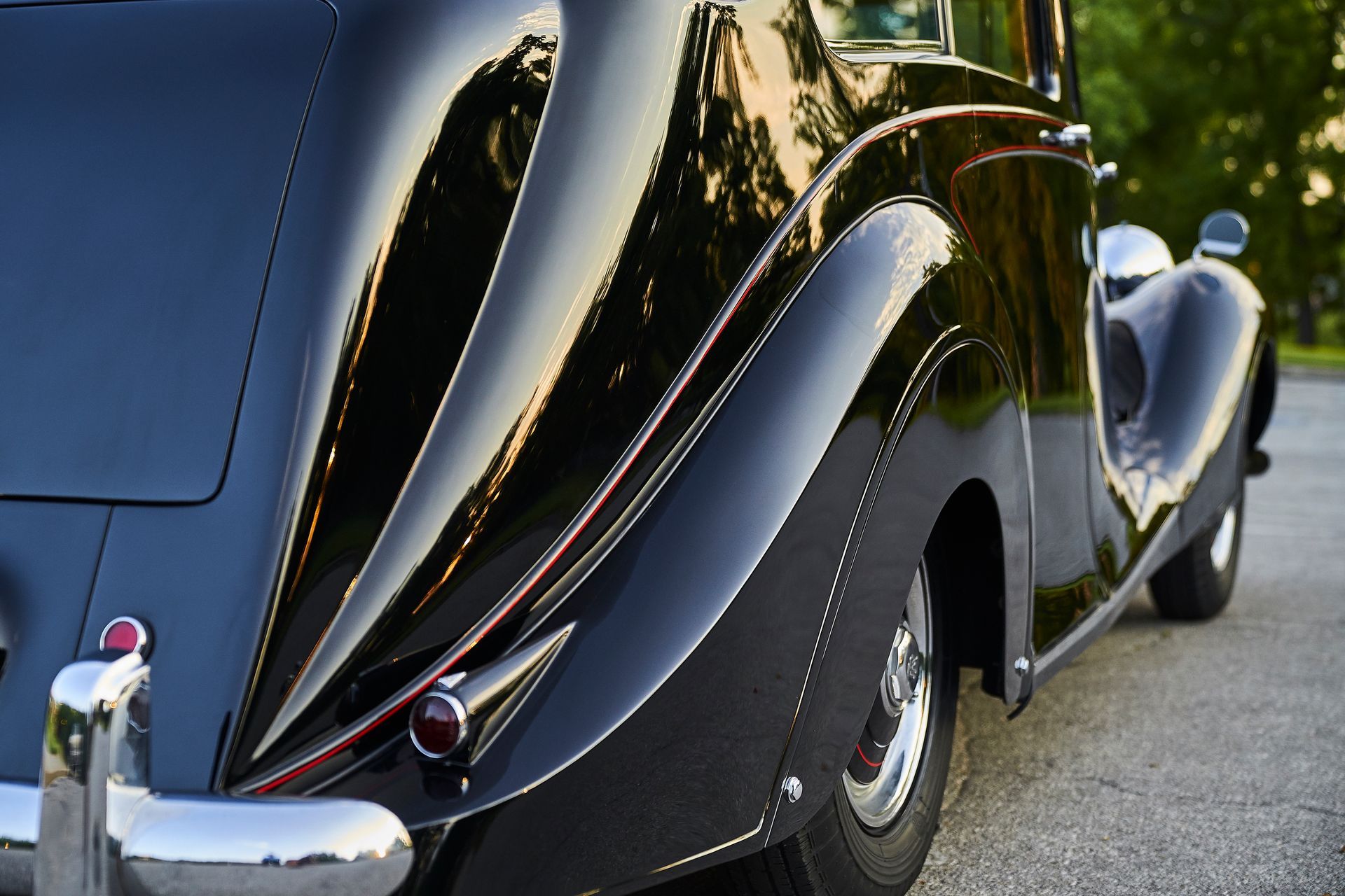 A black car is parked on the side of the road