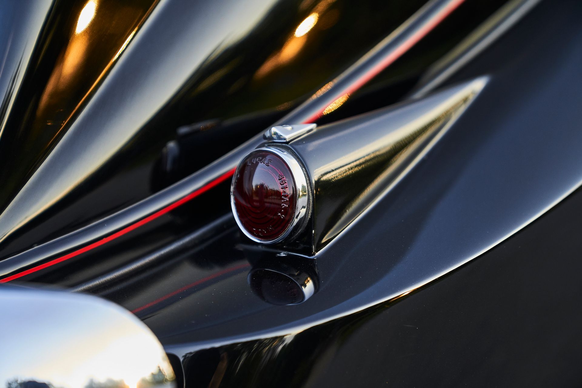 A close up of a tail light on a black car