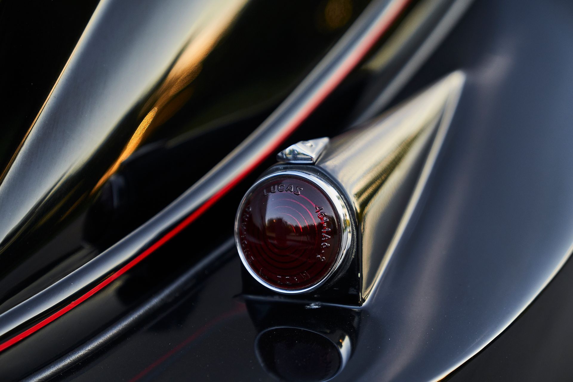A close up of a black car 's tail light