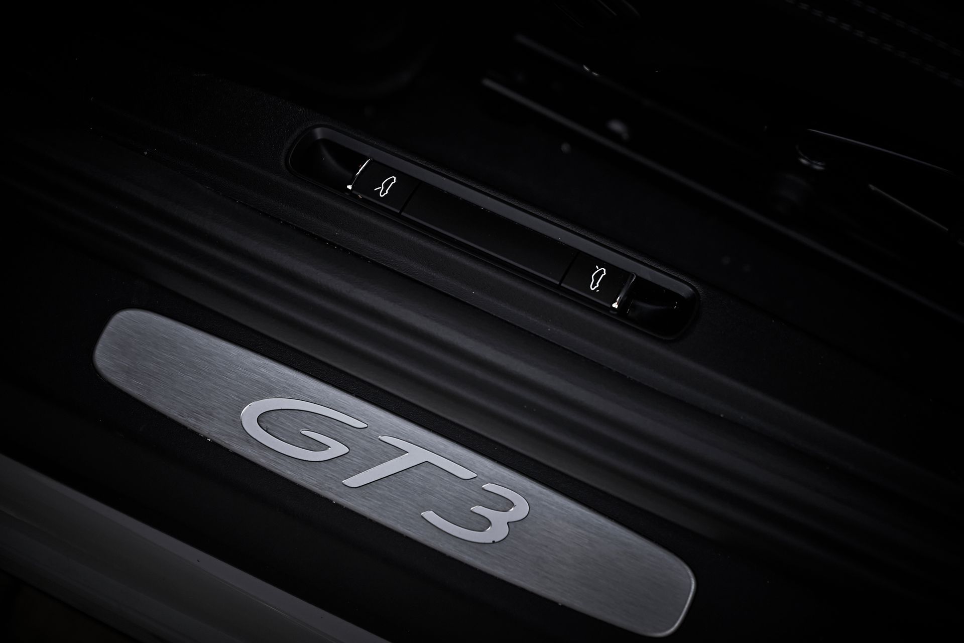 A close up of a car door with the word gt3 on it.