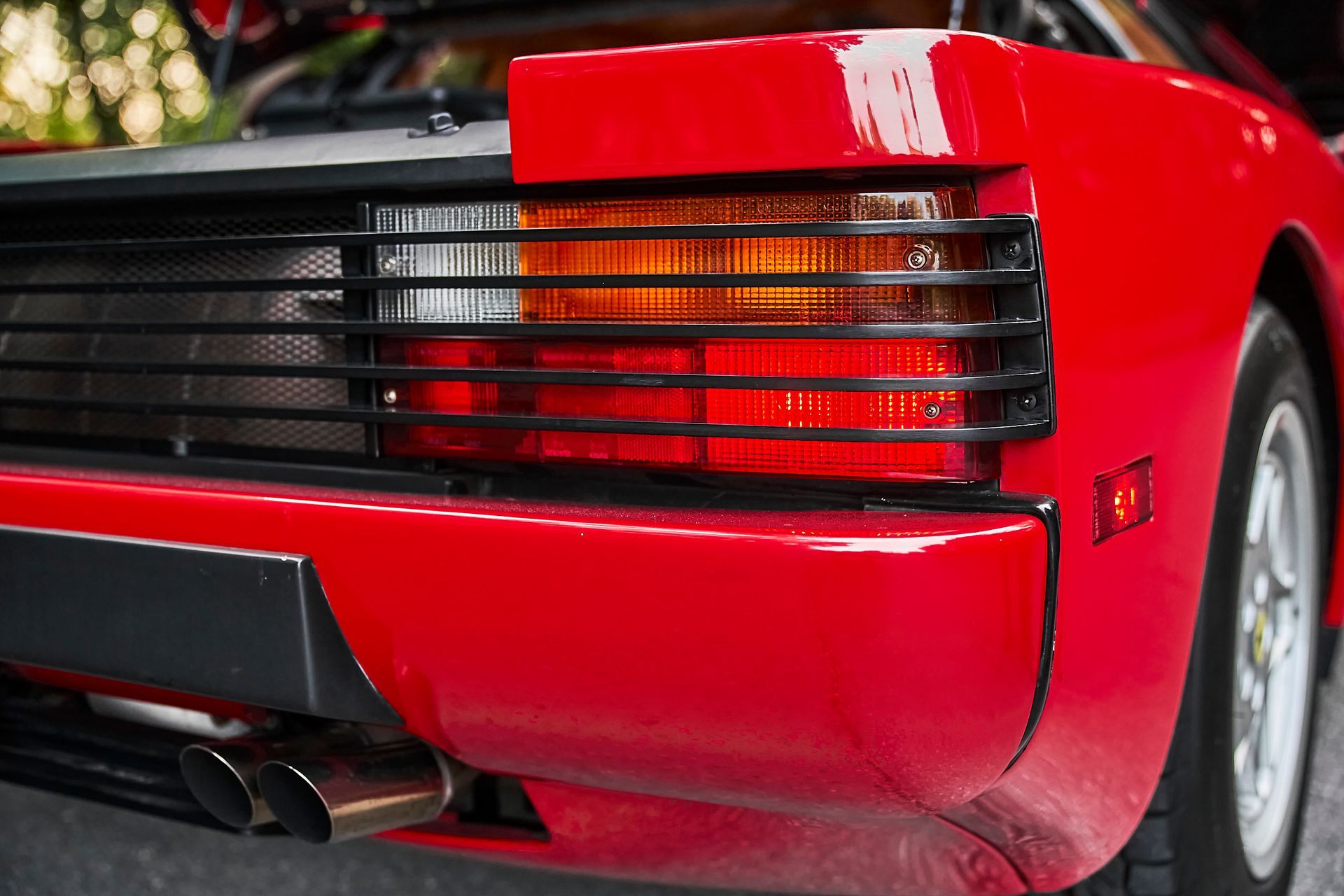 A close up of the rear end of a red sports car.