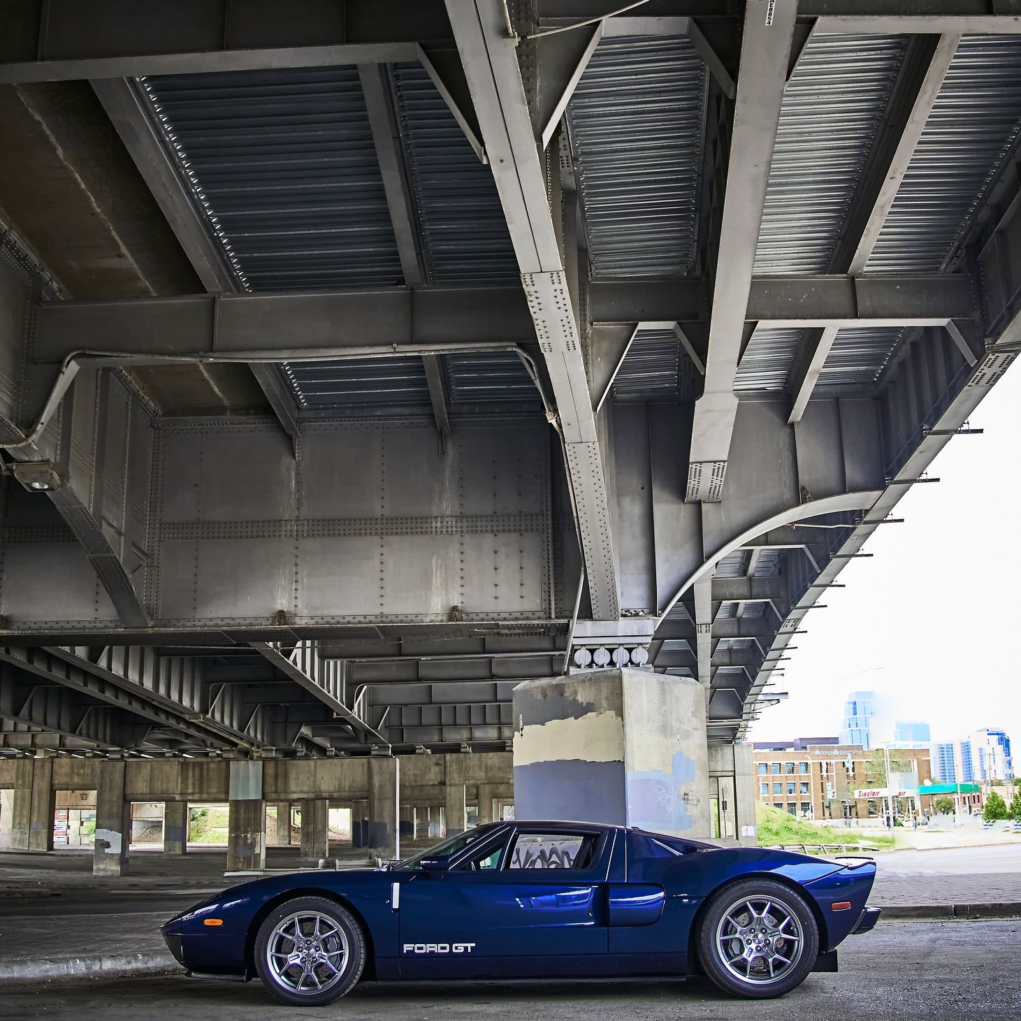 2006 Ford GT -A blue sports car is parked under a bridge
