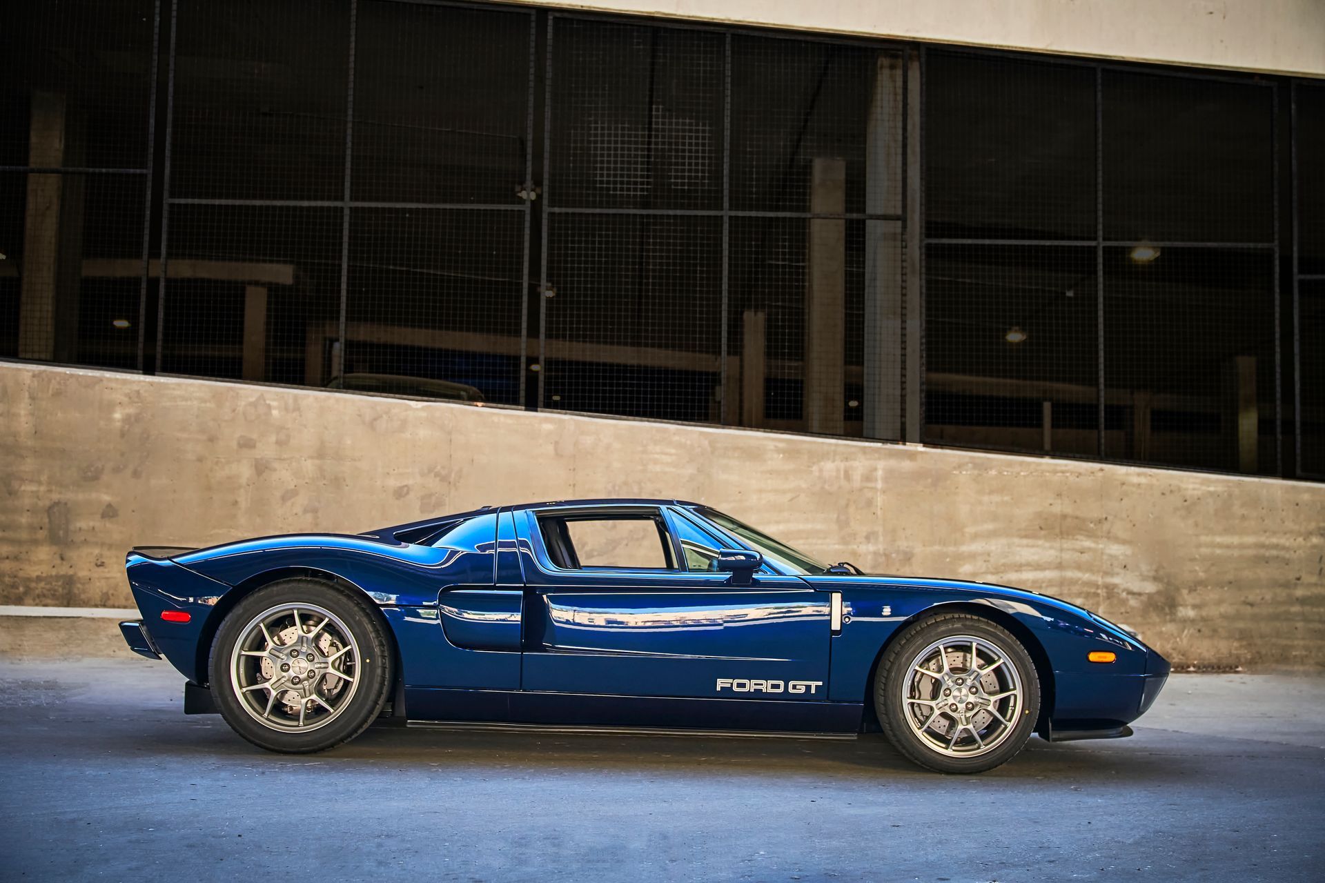 2006 Ford GT -A blue sports car is parked in front of a building.