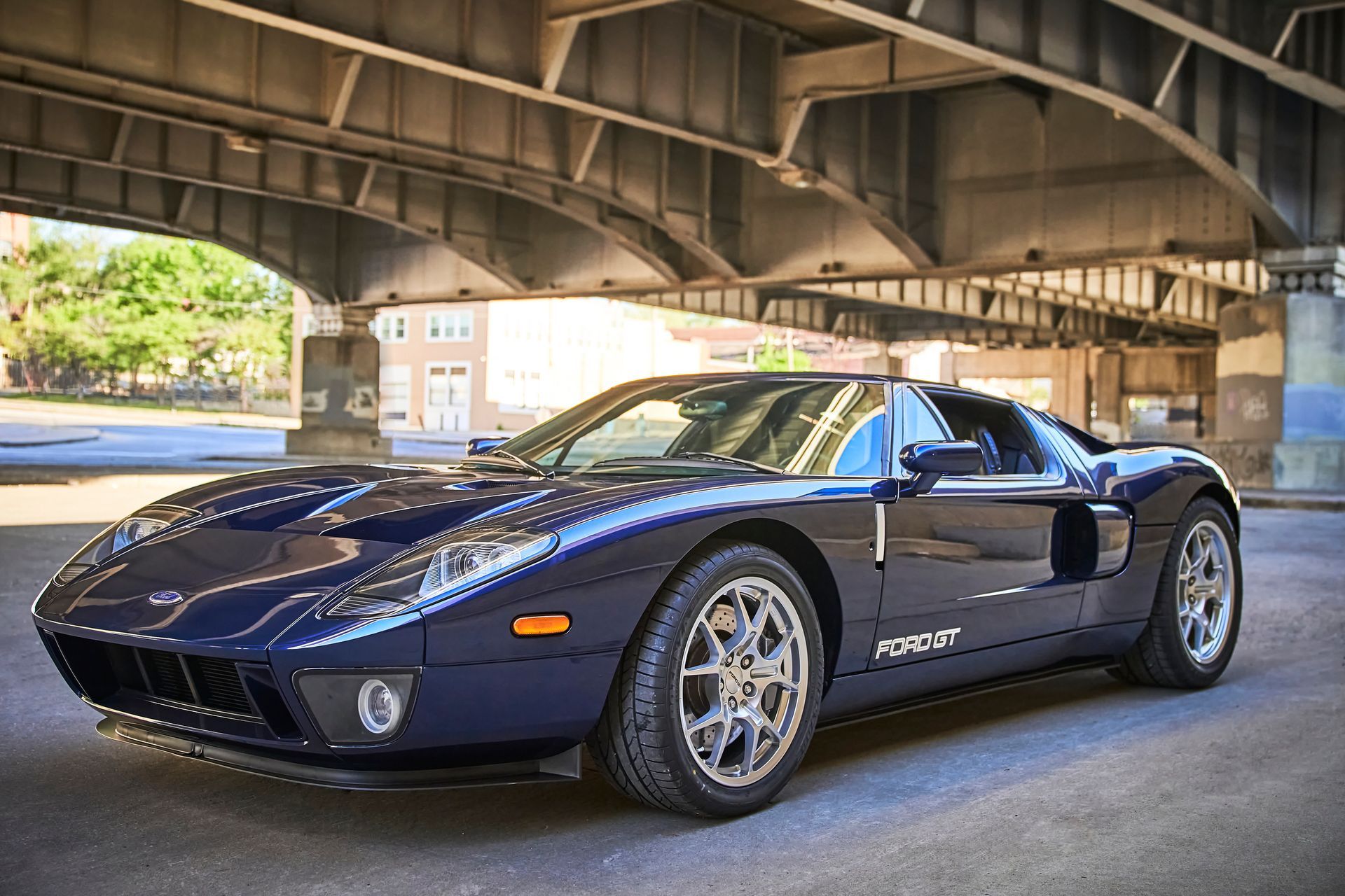 2006 Ford GT -A blue sports car is parked under a bridge.