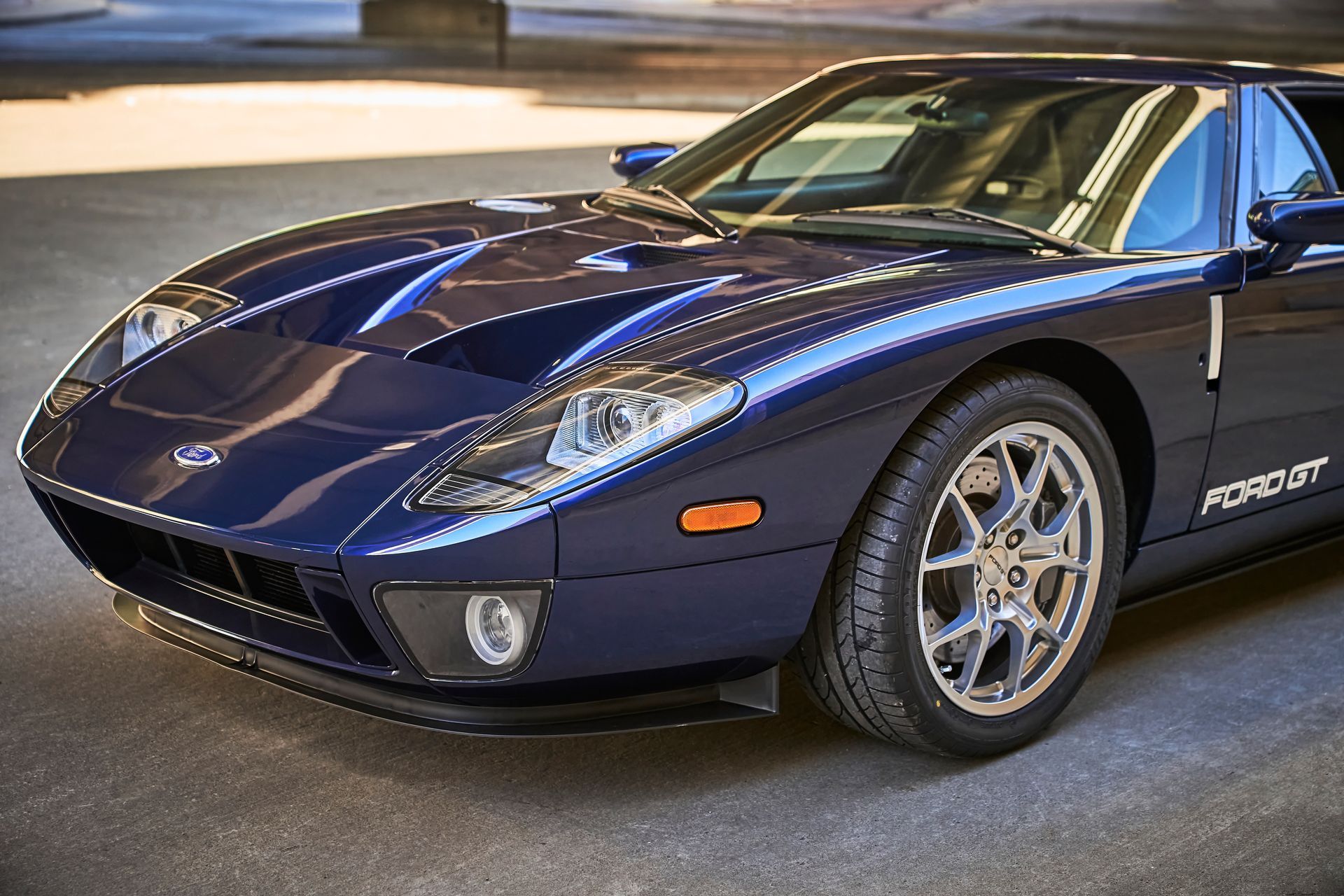 2006 Ford GT -A blue ford gt is parked on the side of the road.