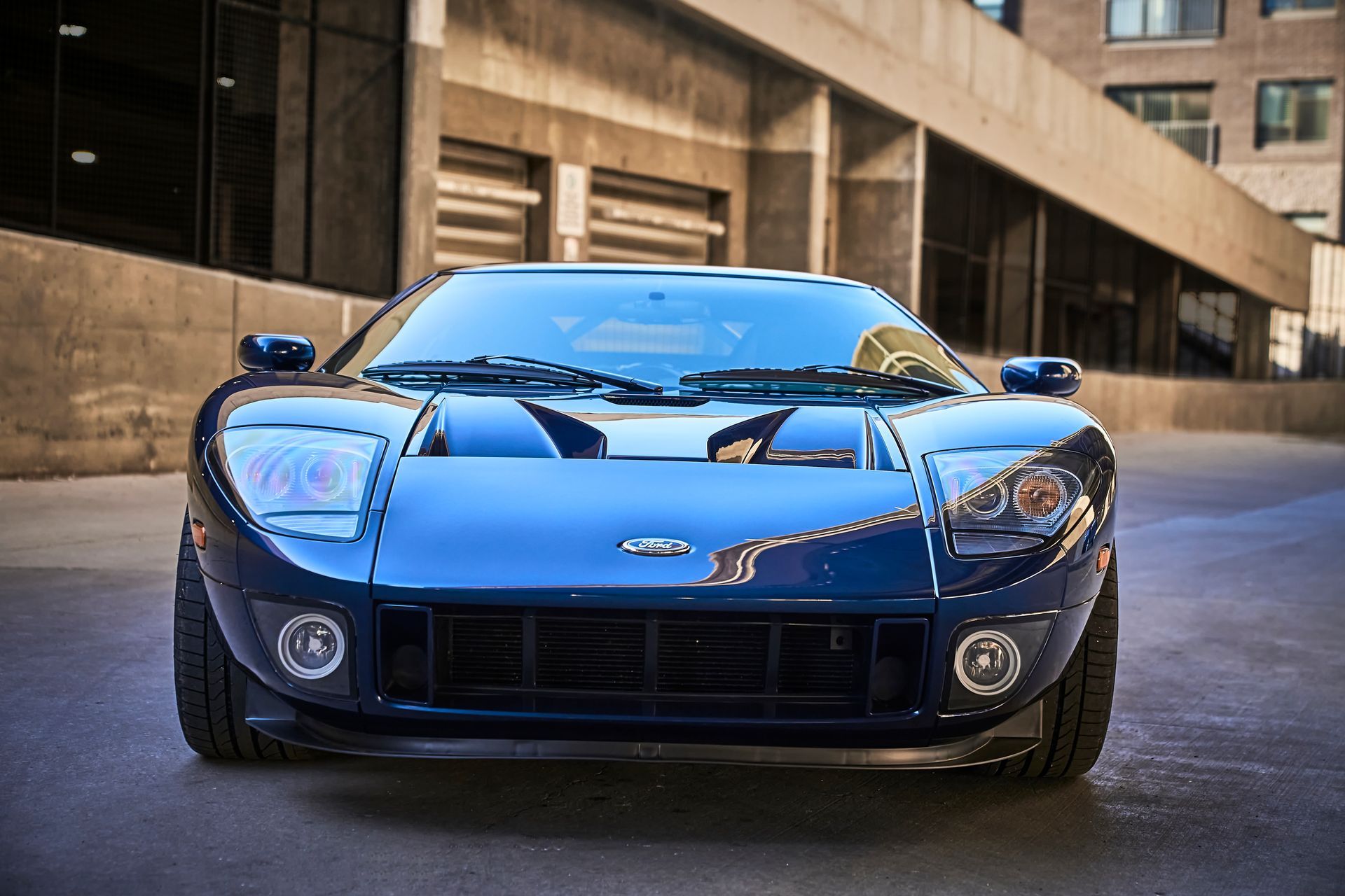 2006 Ford GT -A blue sports car is parked in front of a building.