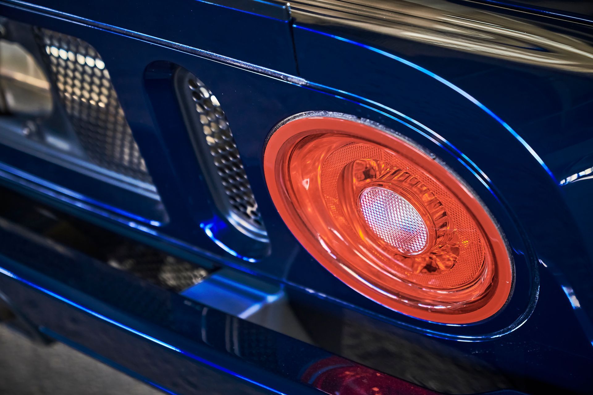 2006 Ford GT -A close up of a blue car with a red tail light.
