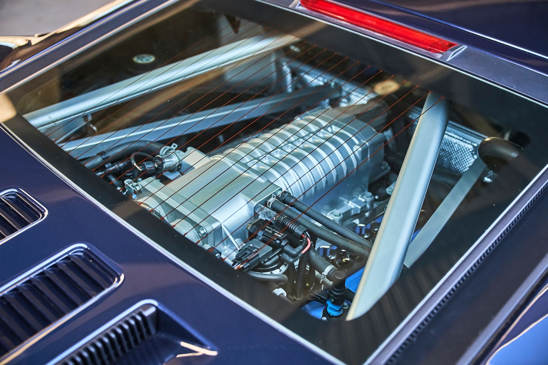 A close up of a car engine with the hood open