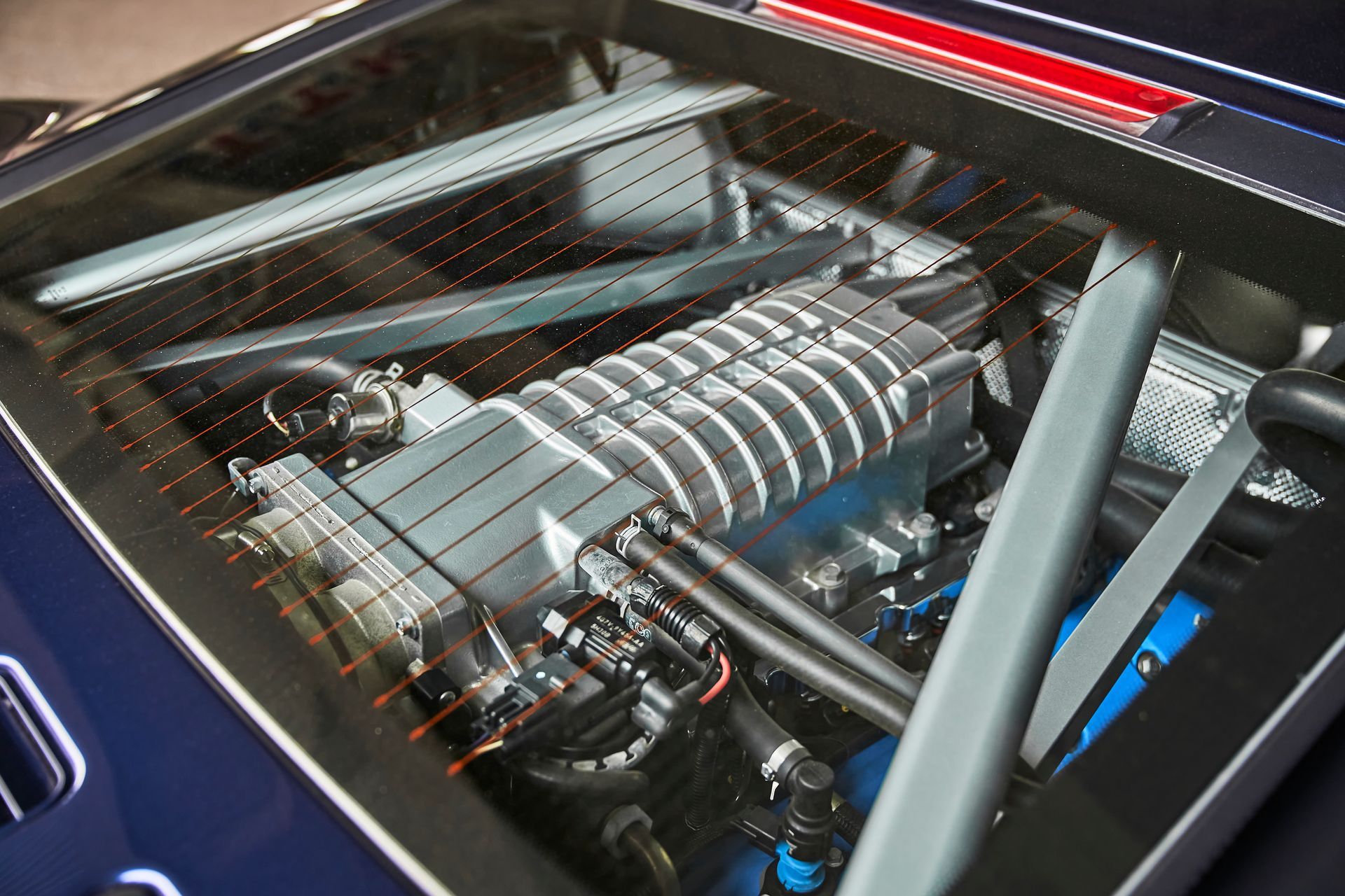 A close up of a car engine with the hood open