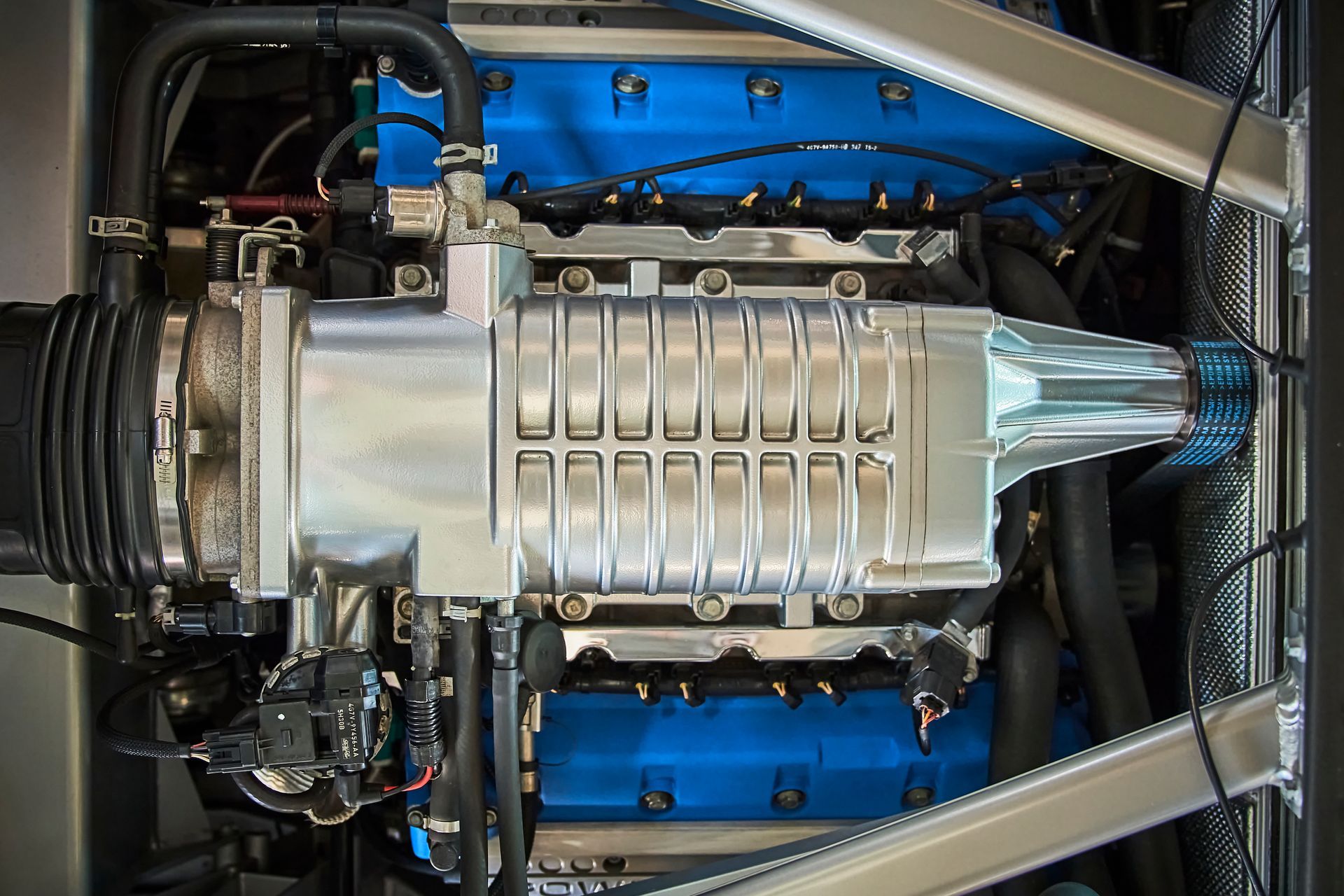 A close up of a car engine with blue valves